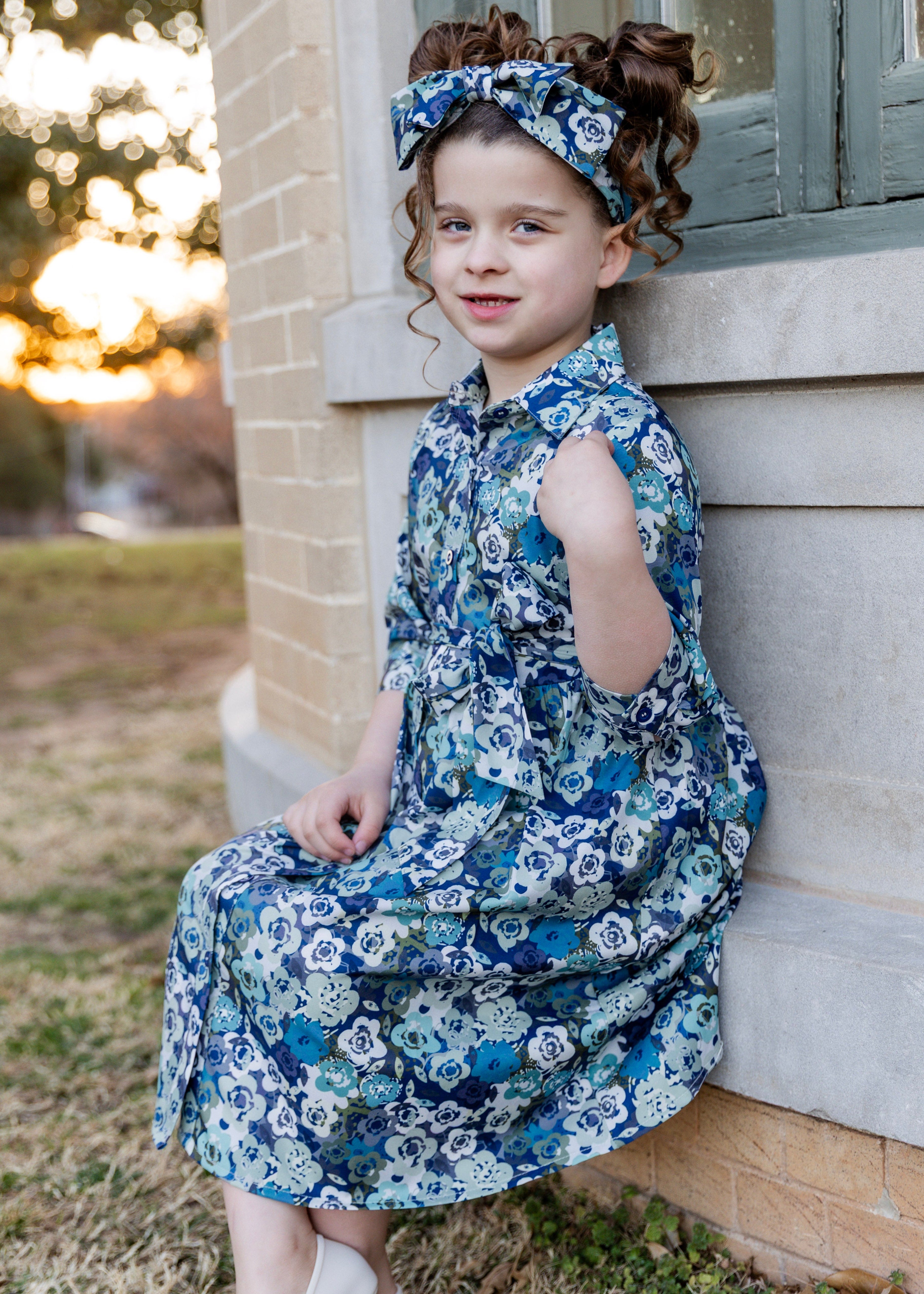 Model wearing the Nuggles® Girls' Rachel Dress and matching Headband in Storm Brush