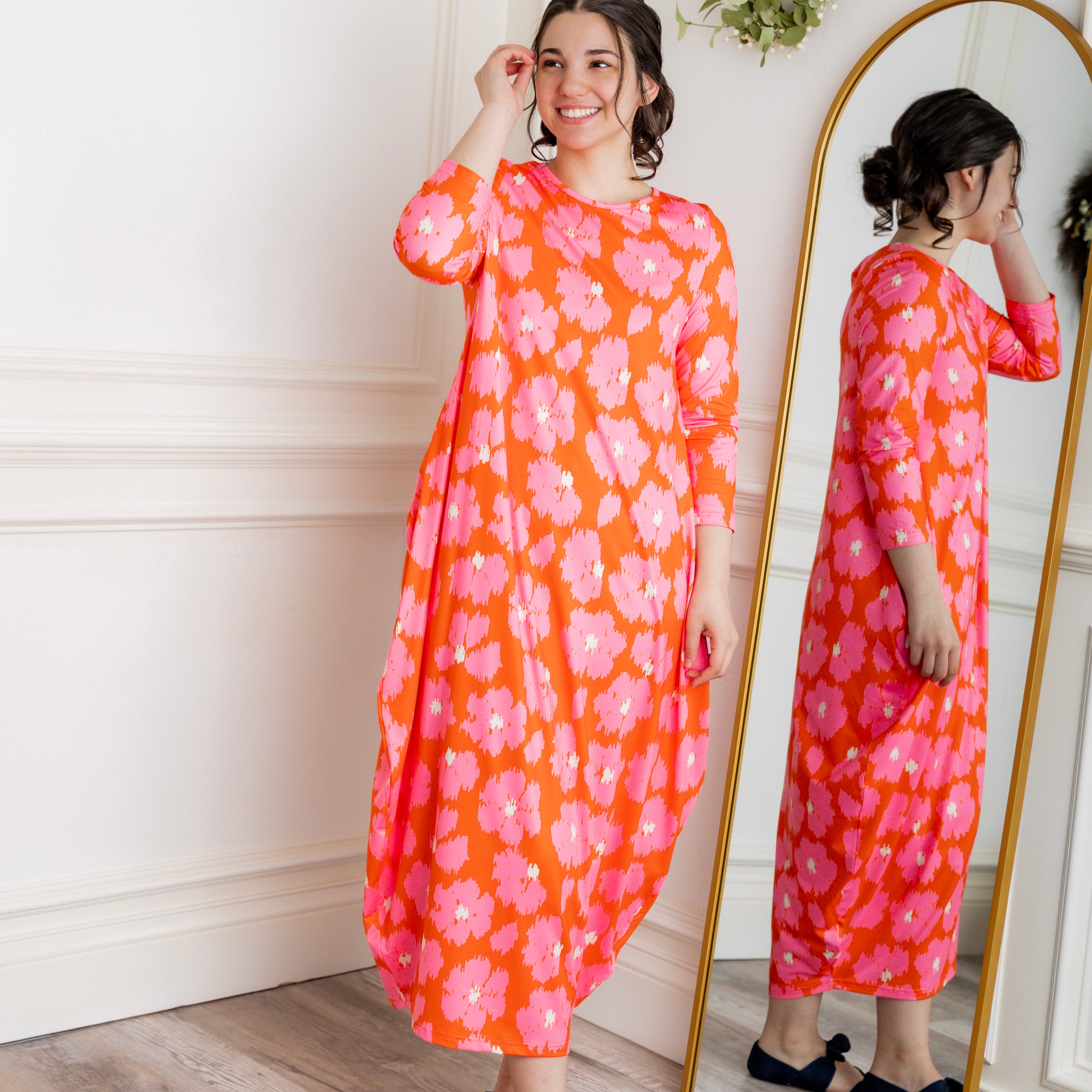 Model wearing Emma Bubble Dress in pretty prints, showcasing full bubble skirt and modest fit.