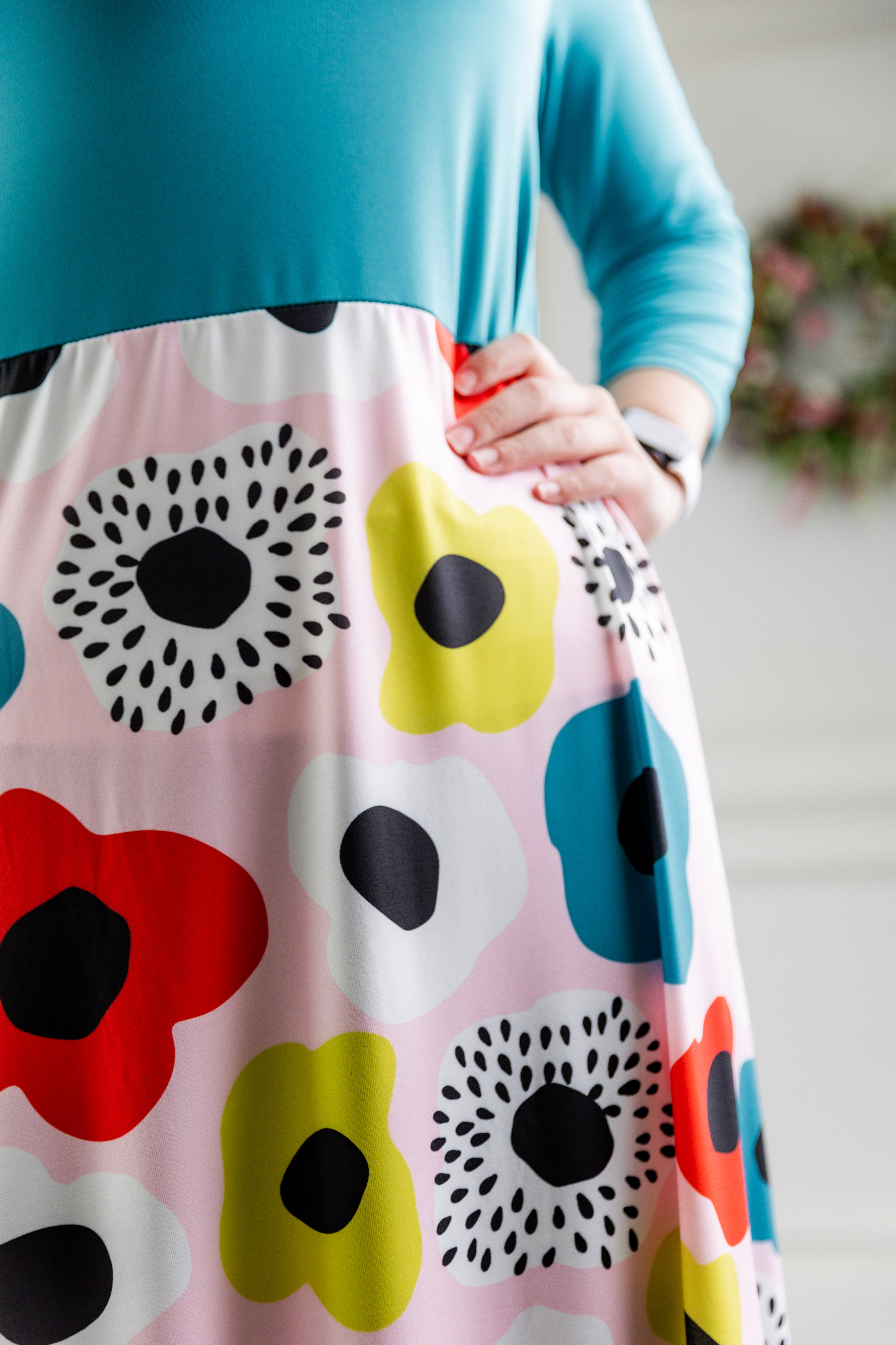 Model modeling Nuggles® Charay Dress with ¾ sleeves and high-low hem. Modest and stylish A-line dress with flattering fit.