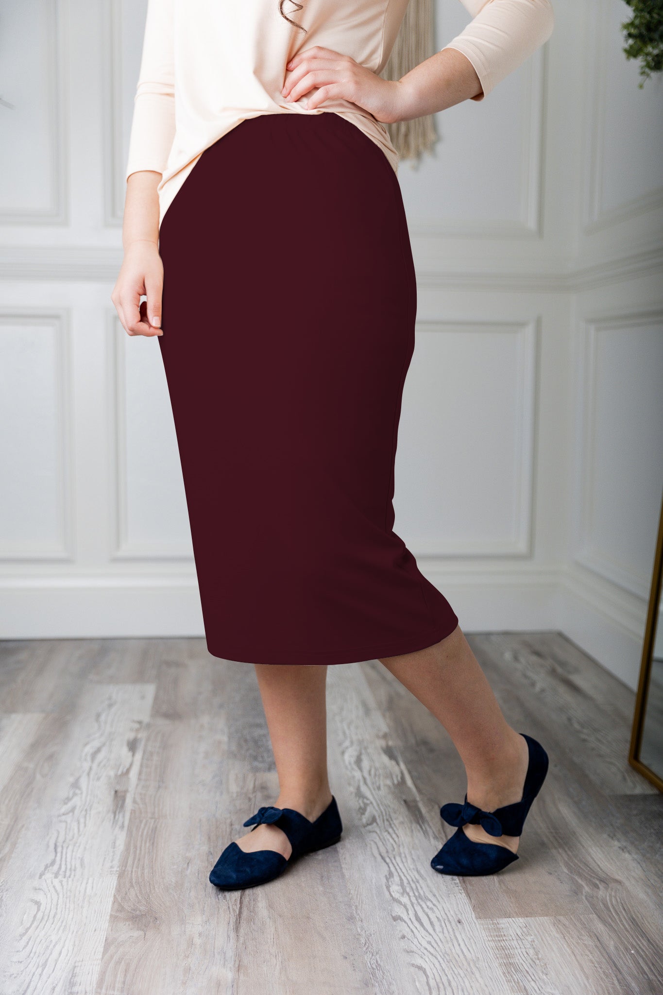 Modest midi skirt in soft knit fabric with a tapered hem and stretch waistband, shown in a classic neutral. A Nuggles favorite in 27", 31", and 34" lengths.