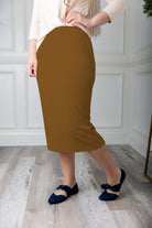 Modest midi skirt in soft knit fabric with a tapered hem and stretch waistband, shown in a classic neutral. A Nuggles favorite in 27", 31", and 34" lengths.
