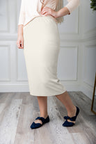 Modest midi skirt in soft knit fabric with a tapered hem and stretch waistband, shown in a classic neutral. A Nuggles favorite in 27", 31", and 34" lengths.