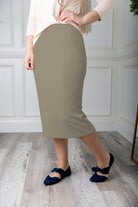 Modest midi skirt in soft knit fabric with a tapered hem and stretch waistband, shown in a classic neutral. A Nuggles favorite in 27", 31", and 34" lengths.