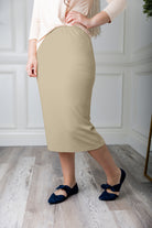 Modest midi skirt in soft knit fabric with a tapered hem and stretch waistband, shown in a classic neutral. A Nuggles favorite in 27", 31", and 34" lengths.
