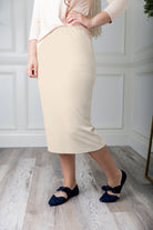 Modest midi skirt in soft knit fabric with a tapered hem and stretch waistband, shown in a classic neutral. A Nuggles favorite in 27", 31", and 34" lengths.