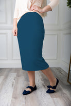 Modest midi skirt in soft knit fabric with a tapered hem and stretch waistband, shown in a classic neutral. A Nuggles favorite in 27", 31", and 34" lengths.