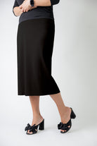 27" relaxed midi skirt displayed in a modest, mid-length cut with a smooth finish.