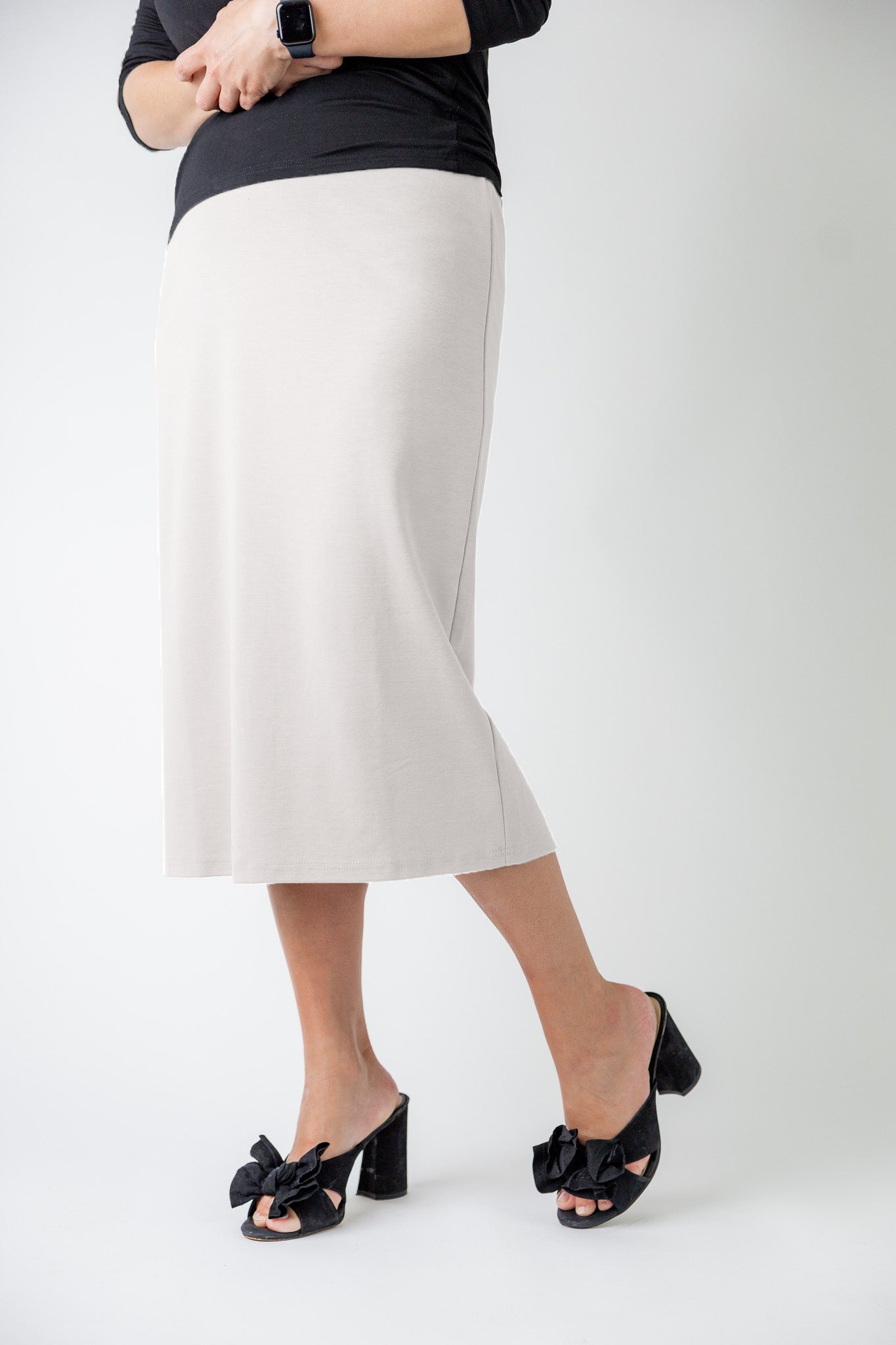 27" relaxed midi skirt displayed in a modest, mid-length cut with a smooth finish.