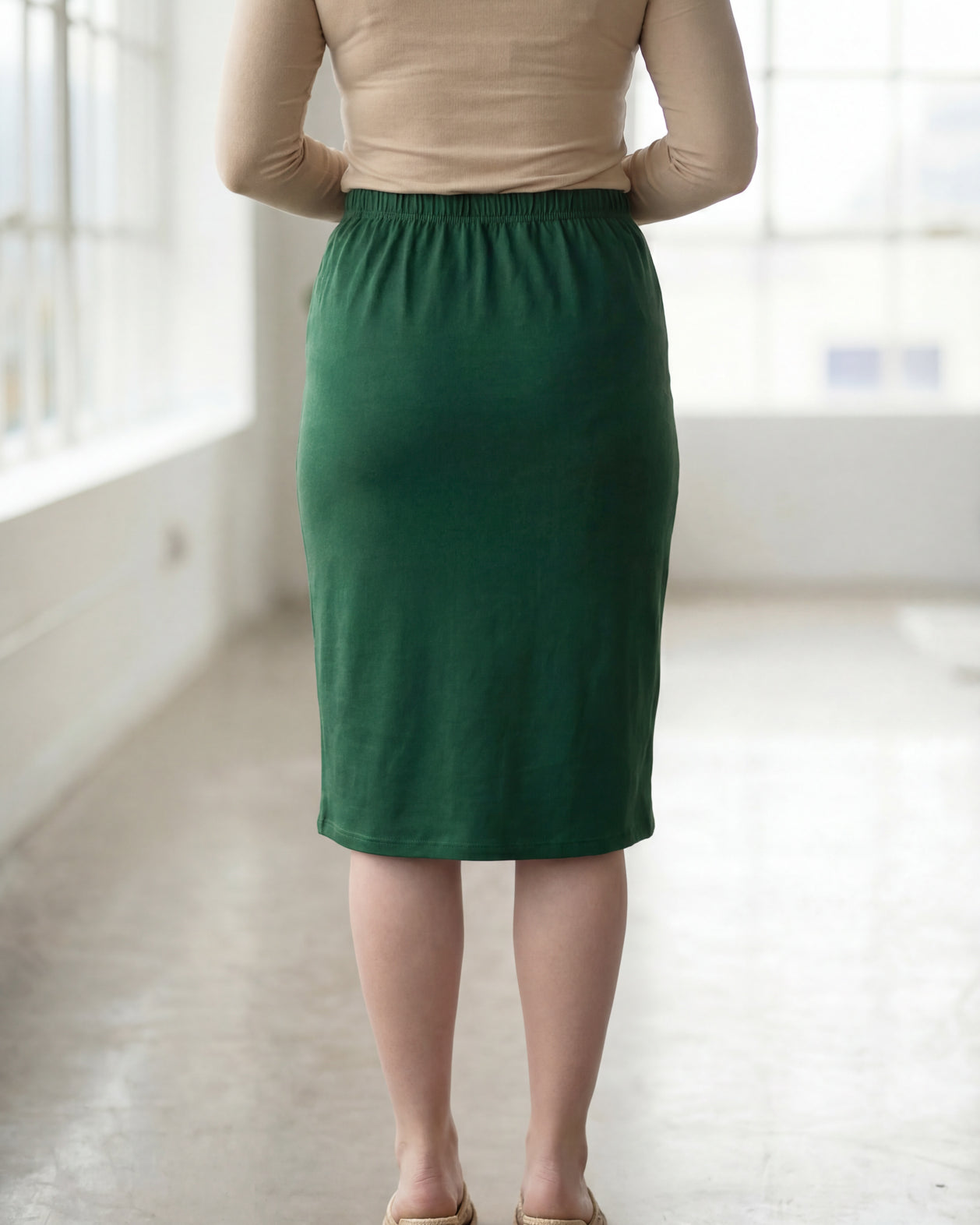 Model wearing Nuggles® 27" Classic Skirt in Pine Green