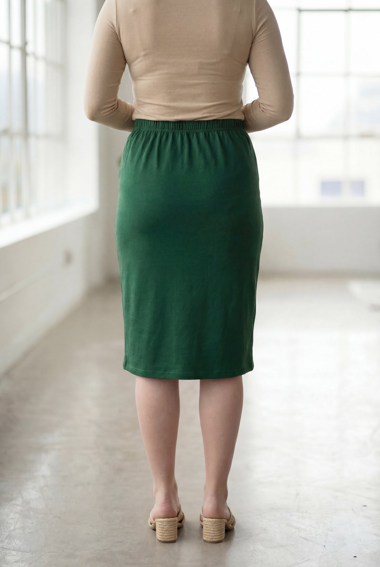 Model wearing Nuggles® 27" Classic Skirt in Pine Green