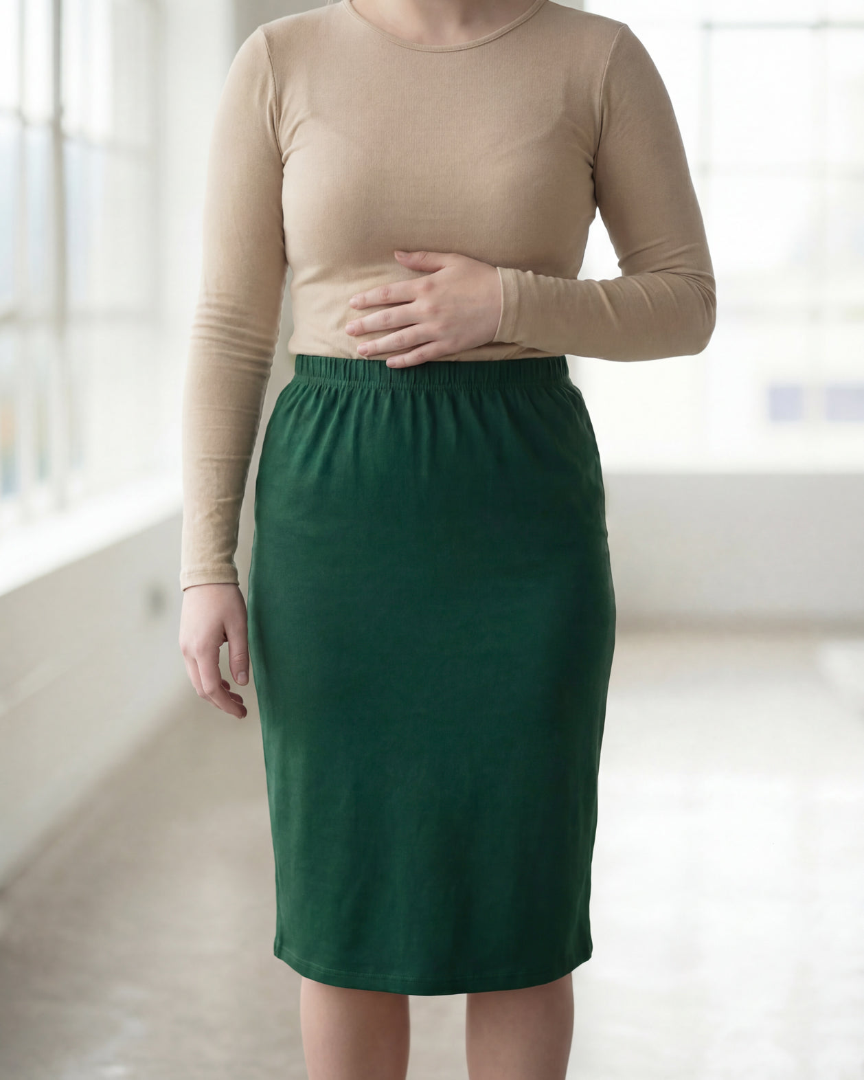 Model wearing Nuggles® 27" Classic Skirt in Pine Green