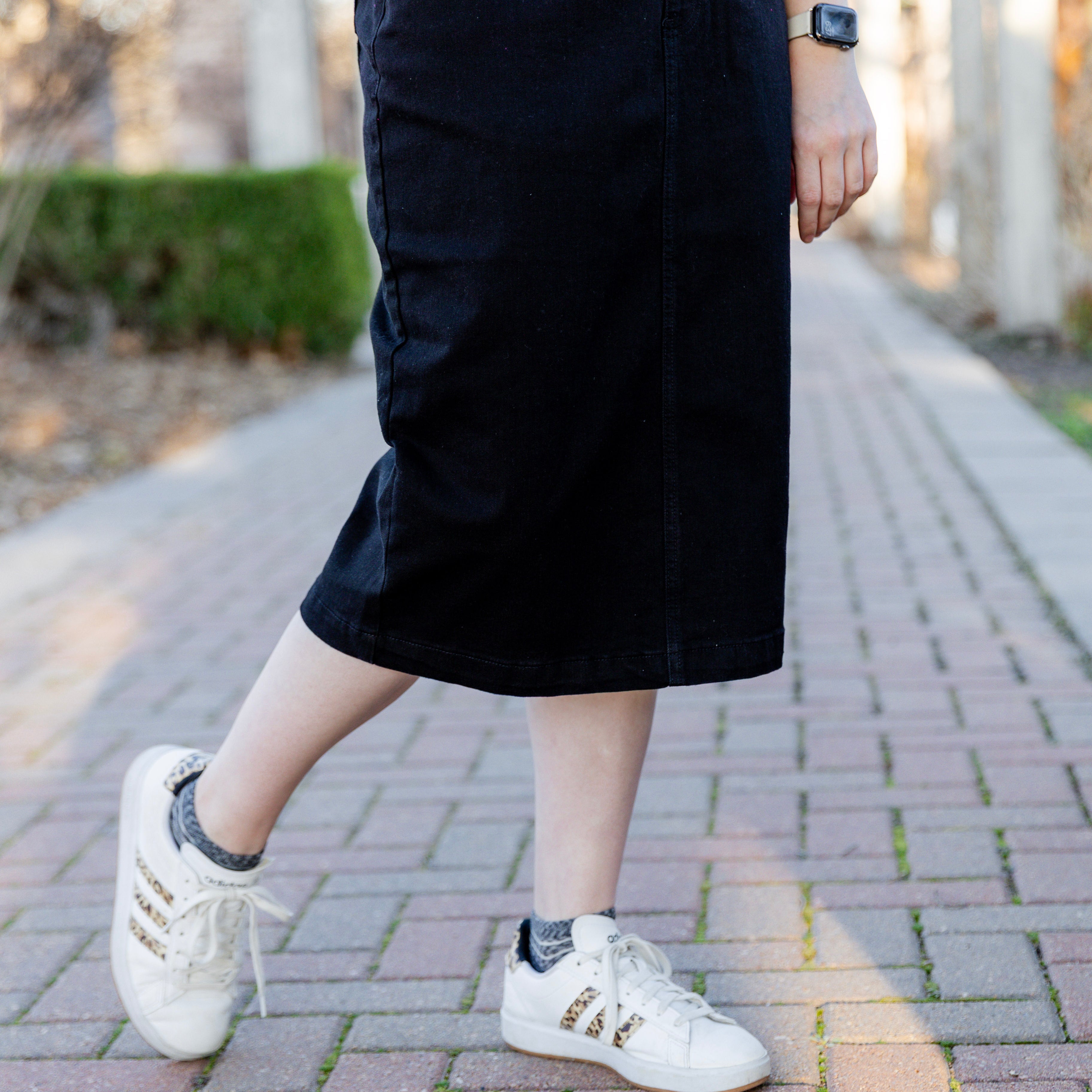 Nuggles denim midi skirt with soft stretch fabric, wide elastic waistband, modest length, and functional pockets. Available in 27", 31", and 34" lengths.