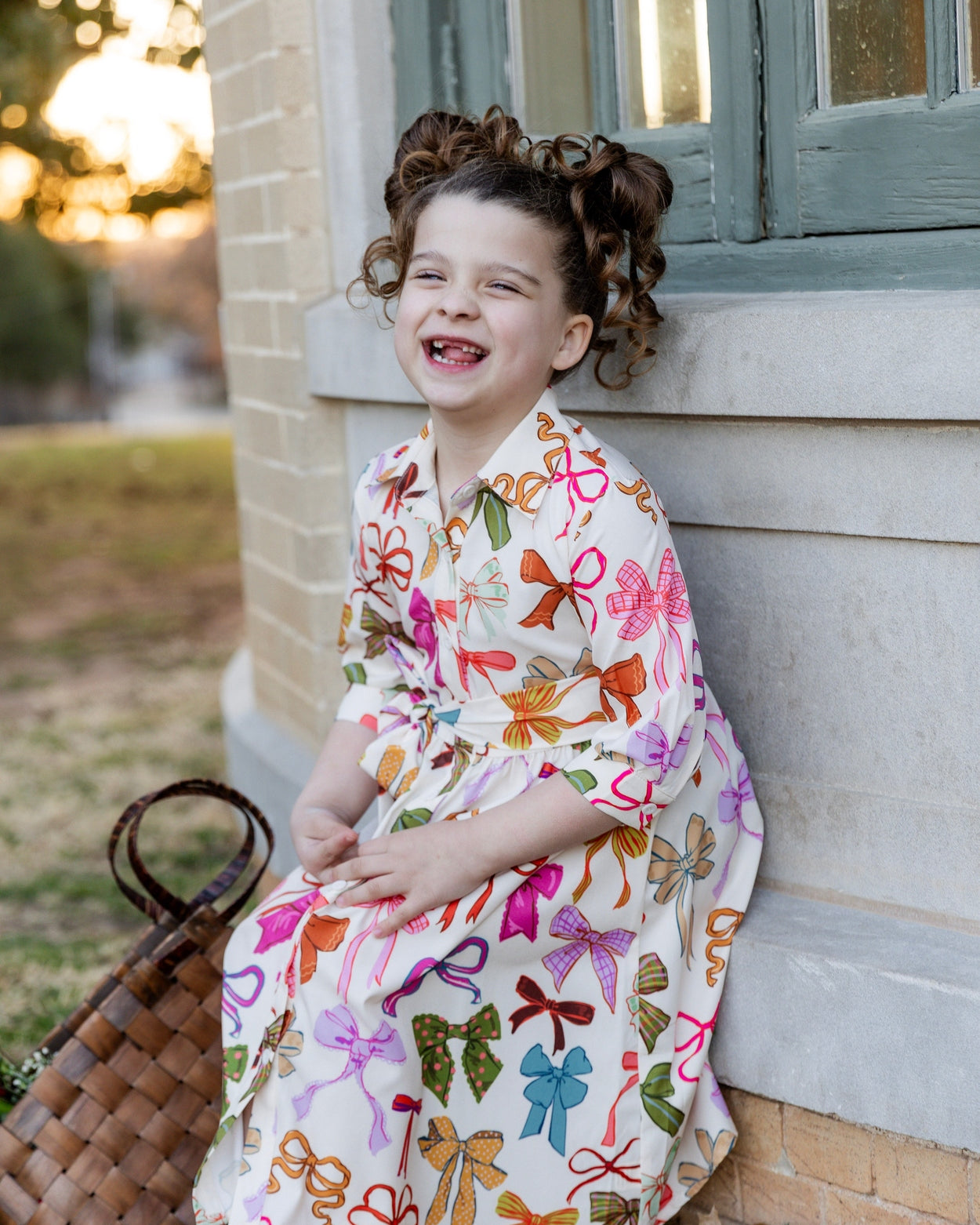 Model wearing the Nuggles® Girls' Rachel Dress in Bow Garden