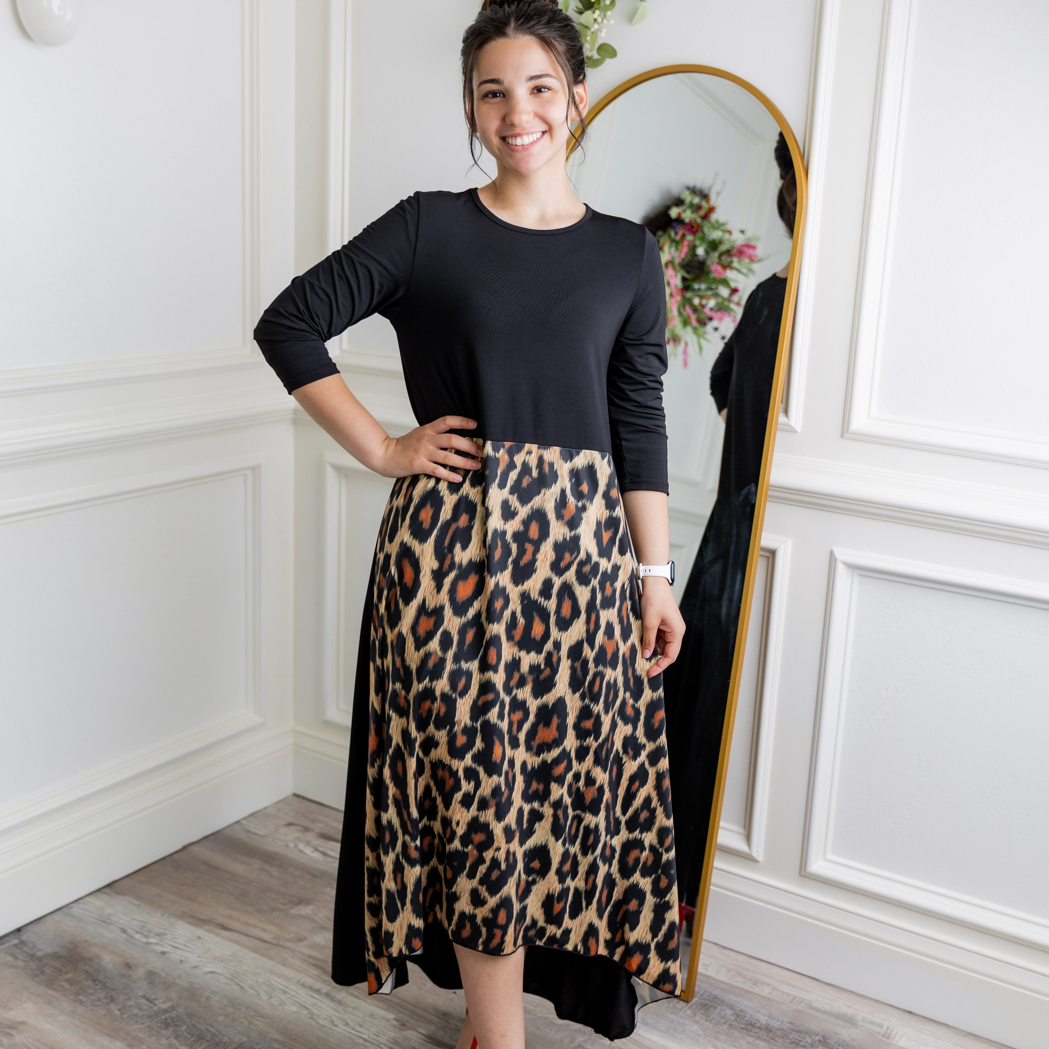 Model modeling Nuggles® Charay Dress with ¾ sleeves and high-low hem. Modest and stylish A-line dress with flattering fit.