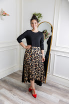 Model modeling Nuggles® Charay Dress with ¾ sleeves and high-low hem. Modest and stylish A-line dress with flattering fit.