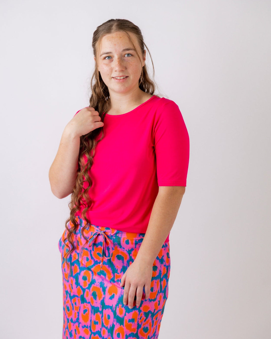 Model wearing the Nuggles® Essential Half Sleeve Tee in Hot Pink