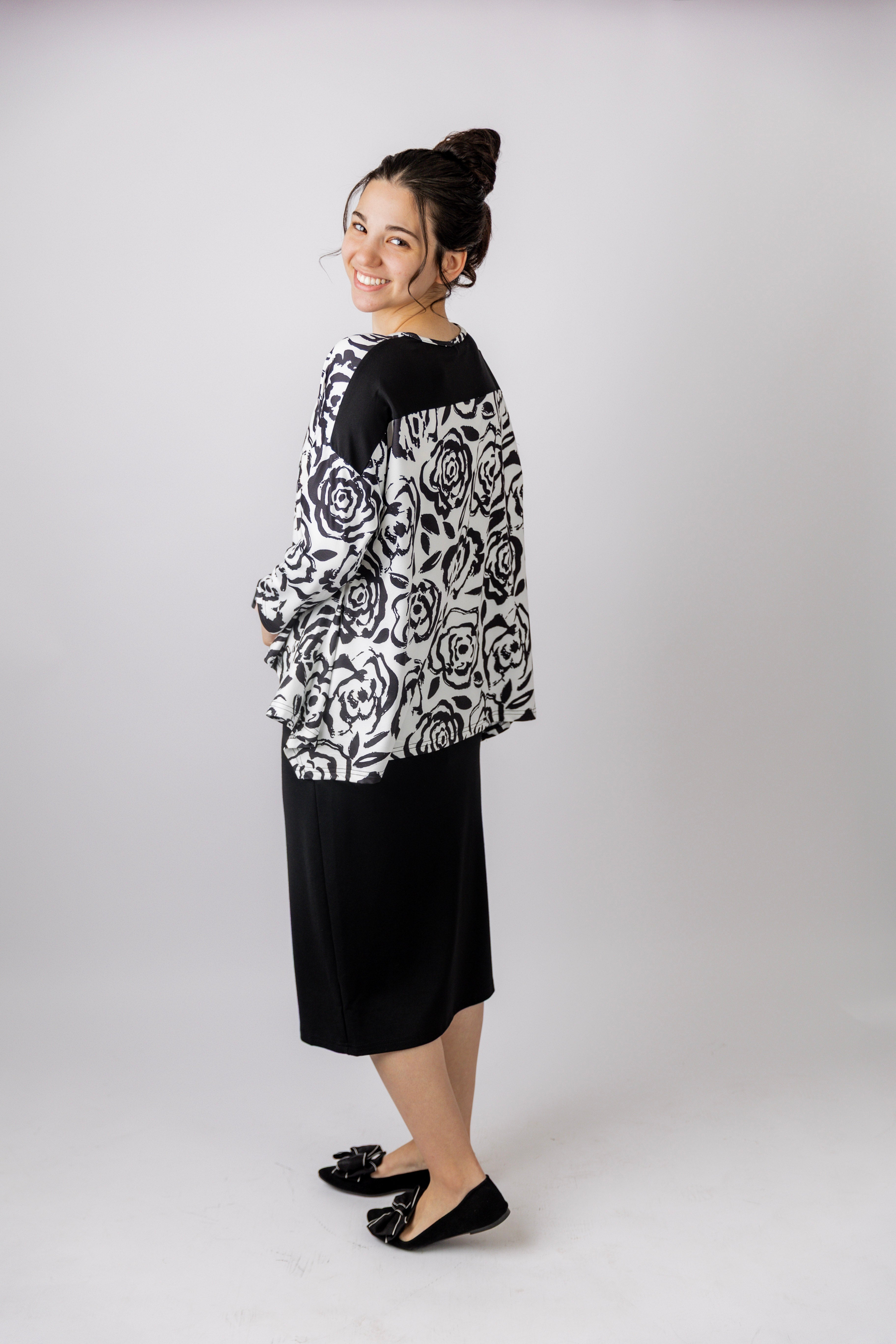 Model wearing the Nuggles® Keegan Top in Midnight Rose print modest boutique top