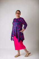 Woman wearing the Sheyanne Top by Nuggles® – modest 3/4-sleeve top with pockets, soft Tiff fabric, styled with a classic skirt for a comfortable and elegant look.