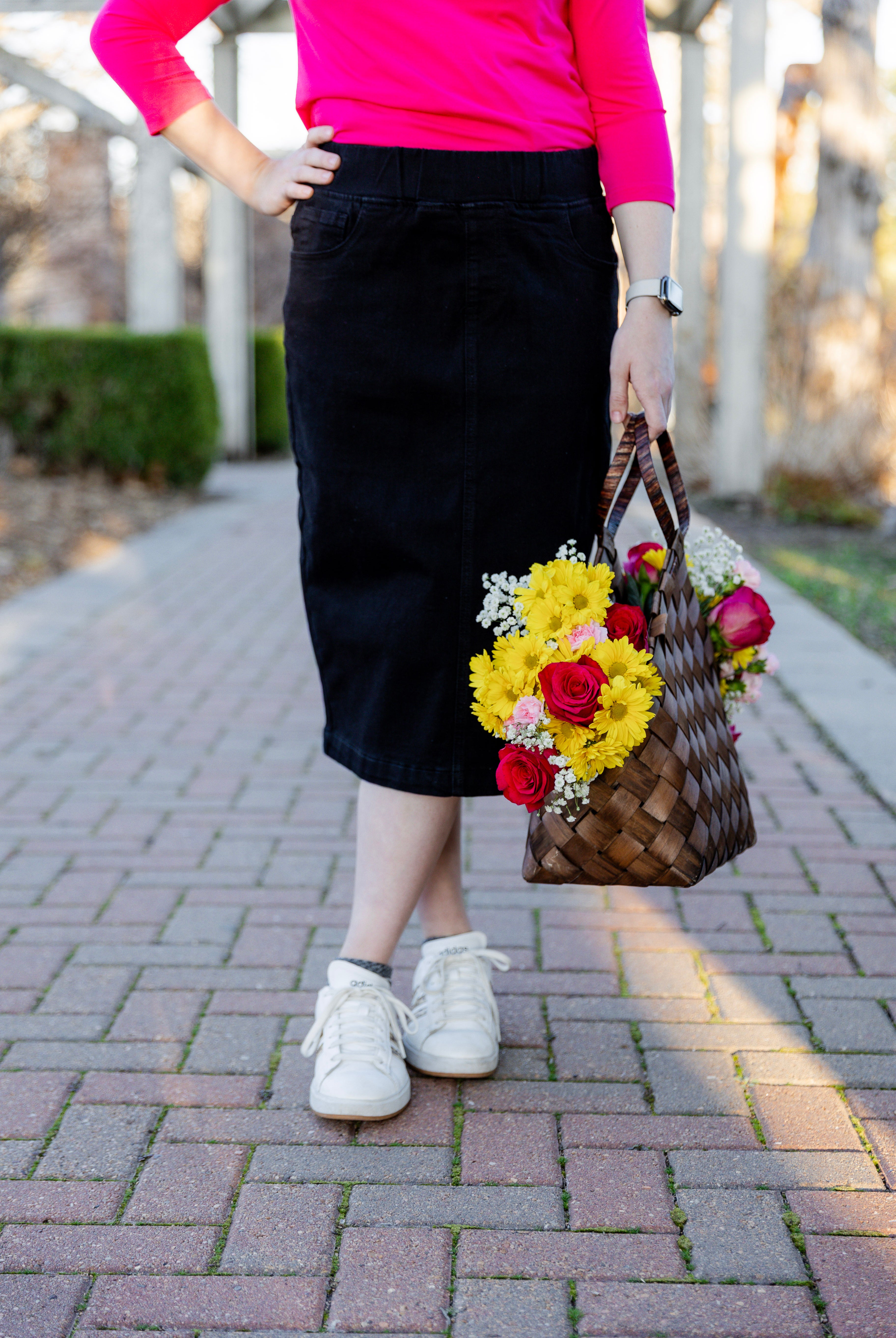 Nuggles® denim midi skirt with soft stretch fabric, wide elastic waistband, modest length, and functional pockets. Available in 27", 31", and 34" lengths.