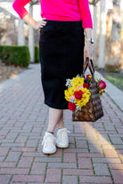 Nuggles® denim midi skirt with soft stretch fabric, wide elastic waistband, modest length, and functional pockets. Available in 27", 31", and 34" lengths.