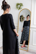 Model modeling Nuggles® Charay Dress with ¾ sleeves and high-low hem. Modest and stylish A-line dress with flattering fit.