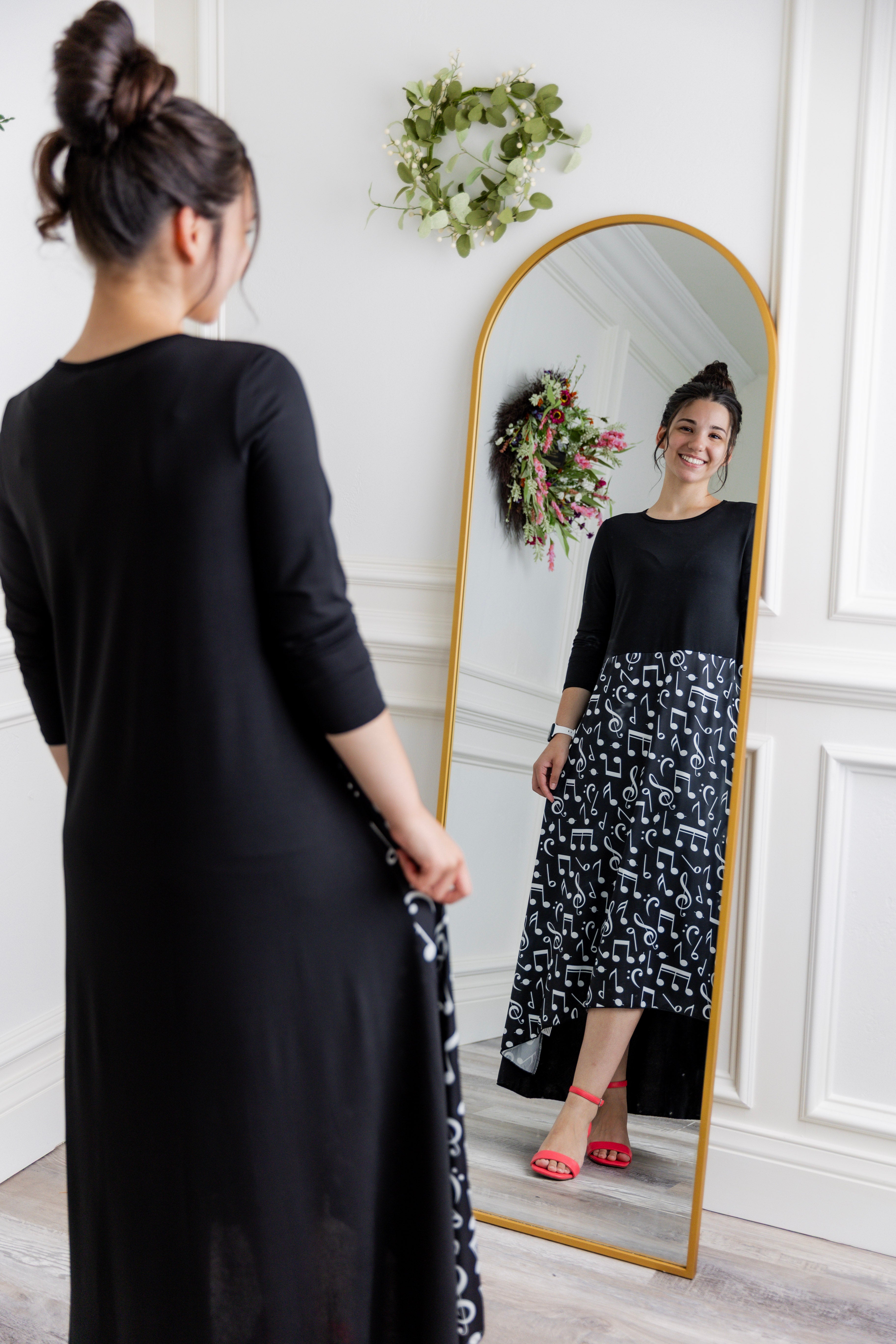 Model modeling Nuggles® Charay Dress with ¾ sleeves and high-low hem. Modest and stylish A-line dress with flattering fit.