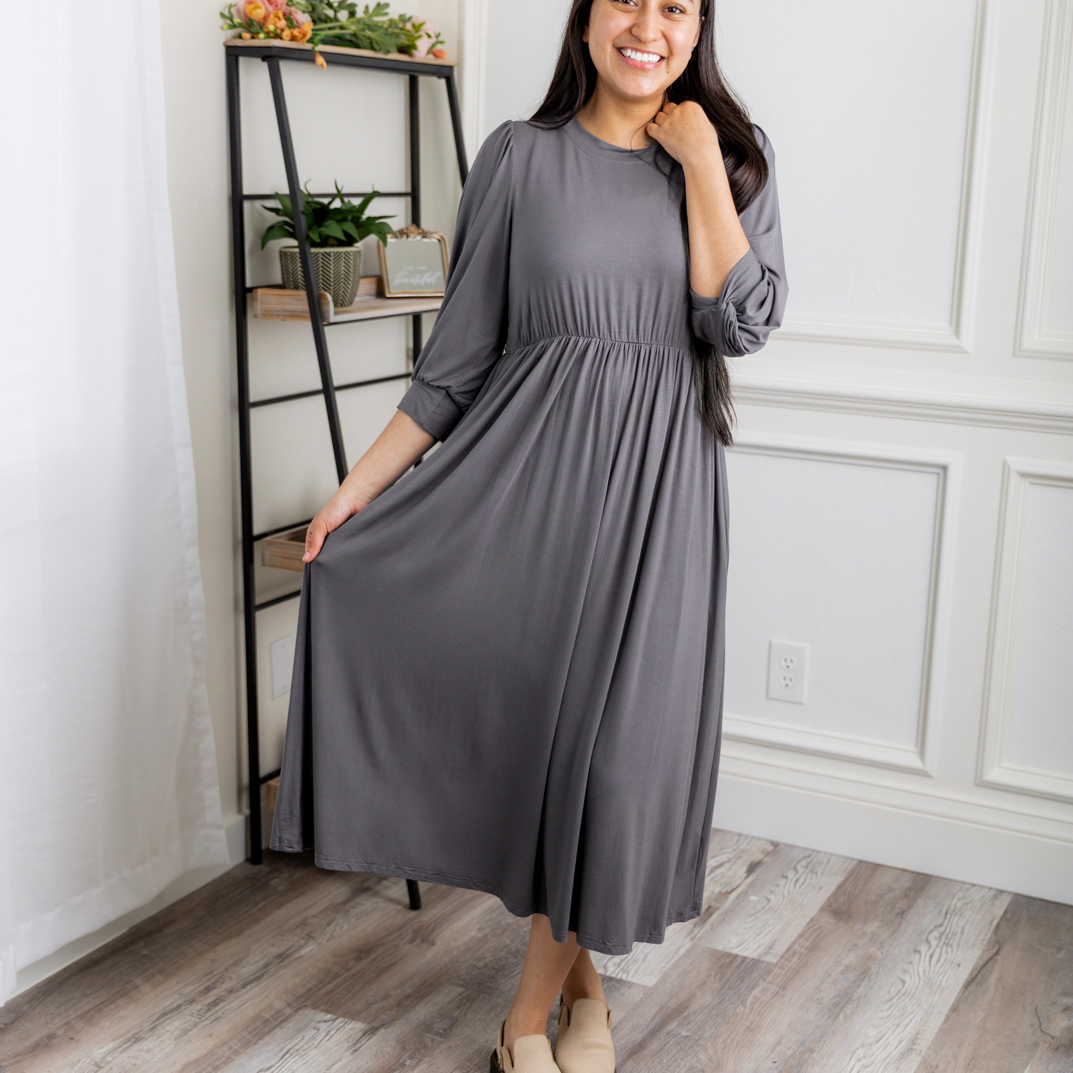 Modest Willow Solid Colors Dress by Nuggles® featuring a gathered waist, balloon sleeves, and side pockets; shown in various solid colors and angles for a stylish, comfortable everyday look.