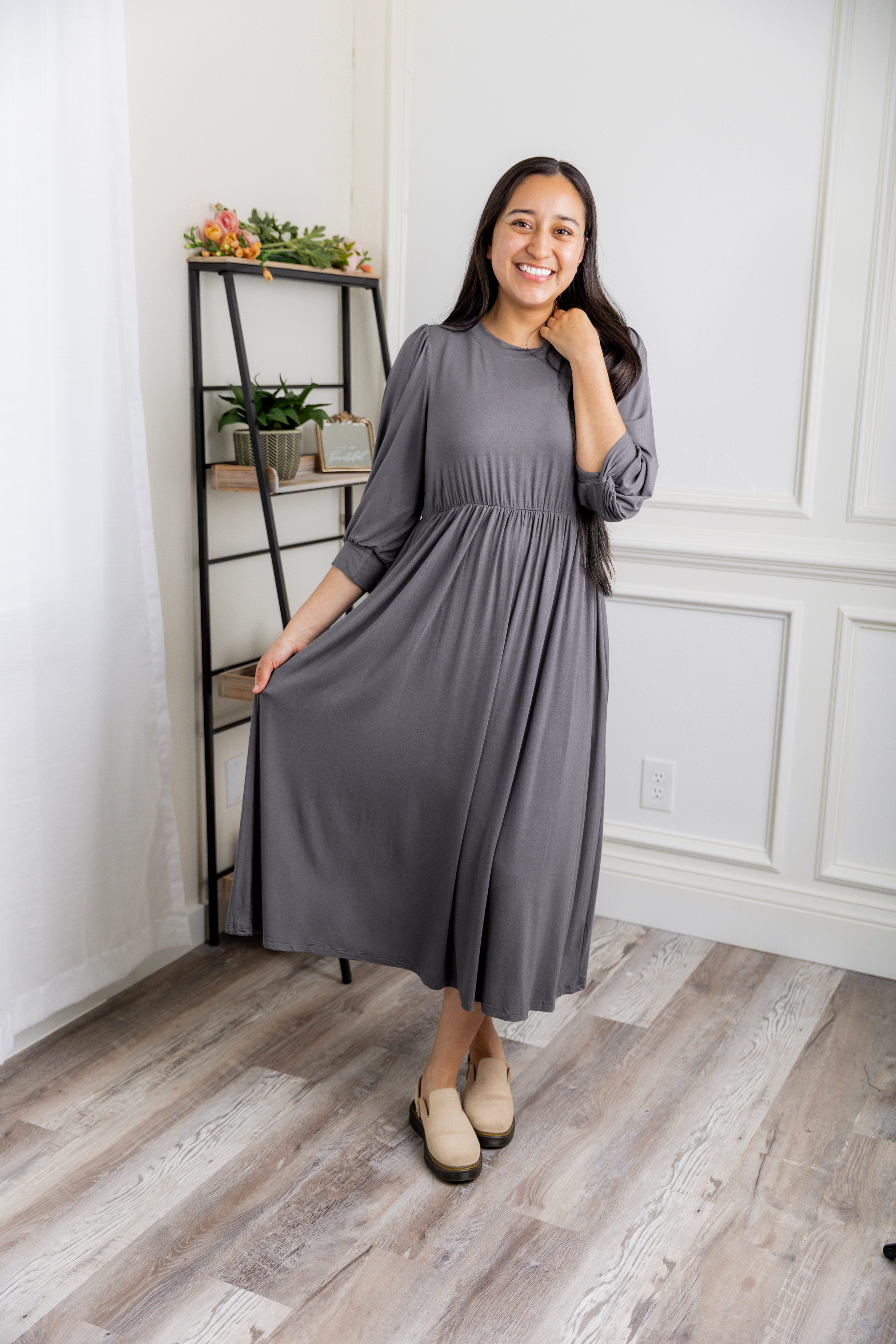 Modest Willow Solid Colors Dress by Nuggles® featuring a gathered waist, balloon sleeves, and side pockets; shown in various solid colors and angles for a stylish, comfortable everyday look.