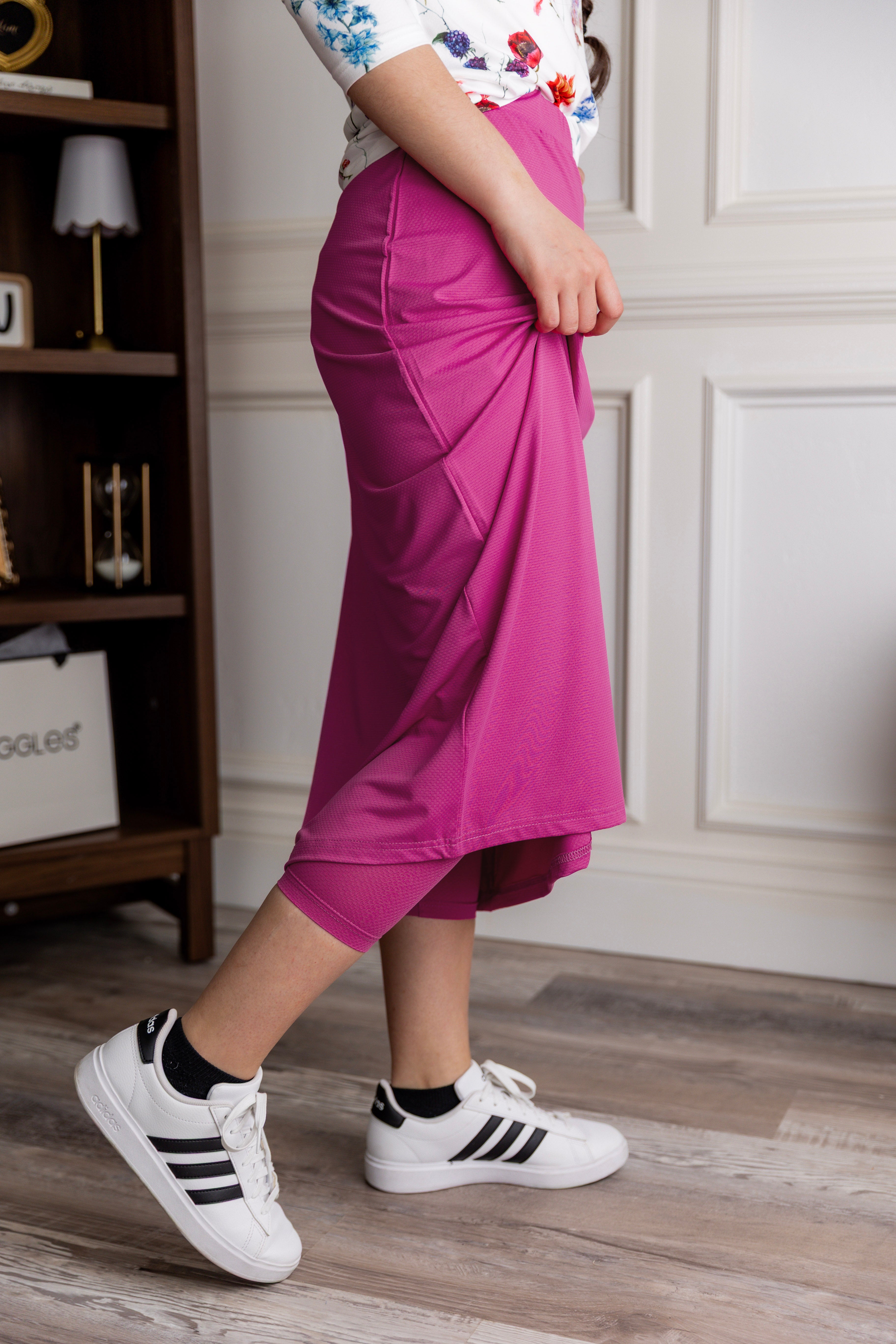 Model wearing Nuggles® 31" All-Sport Skirt in Hot Pink