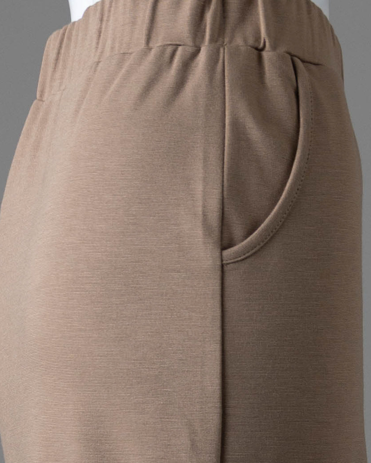 Model wearing Nuggles® 34" Pocket Classic Skirt in Taupe