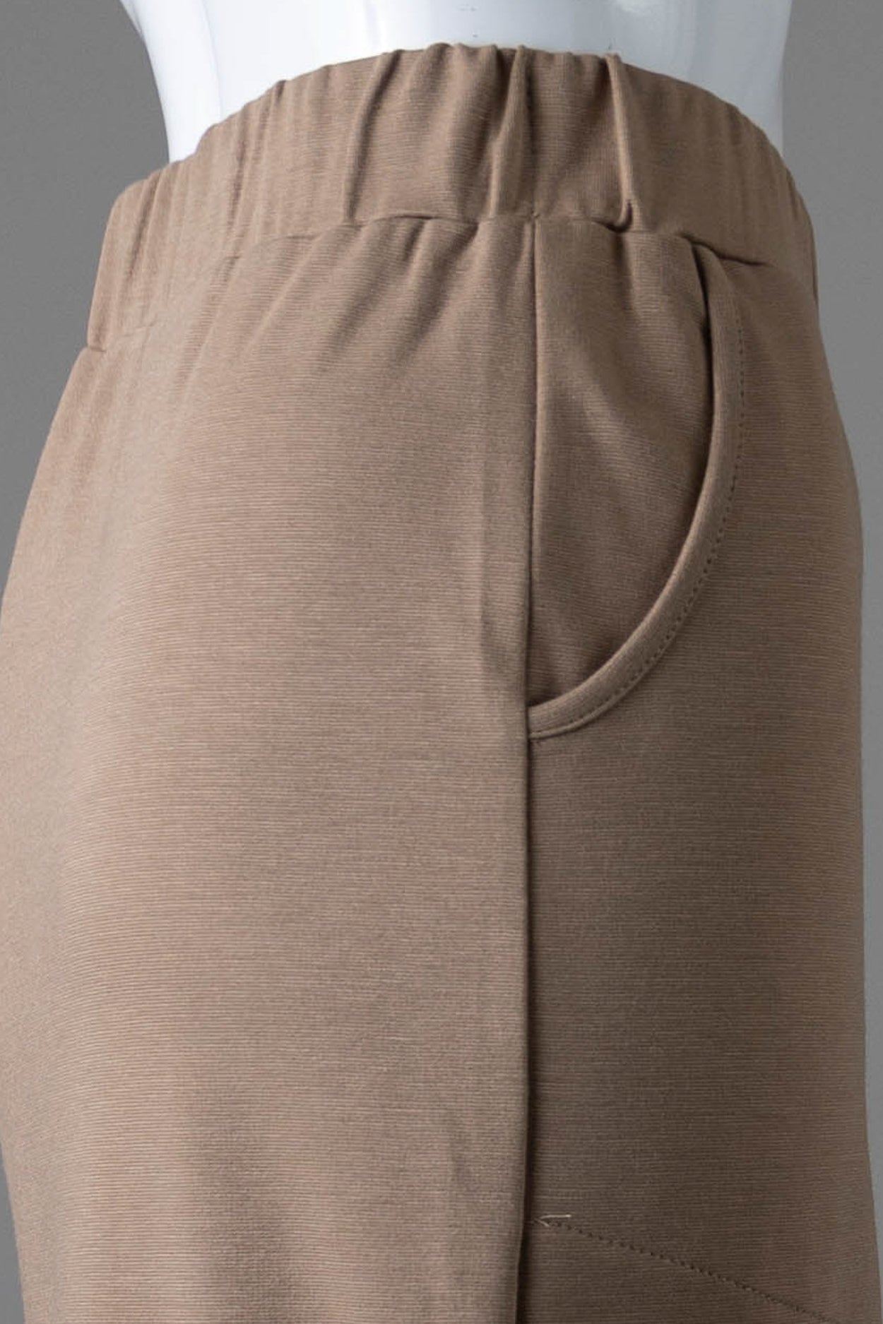 Model wearing Nuggles® 34" Pocket Classic Skirt in Taupe