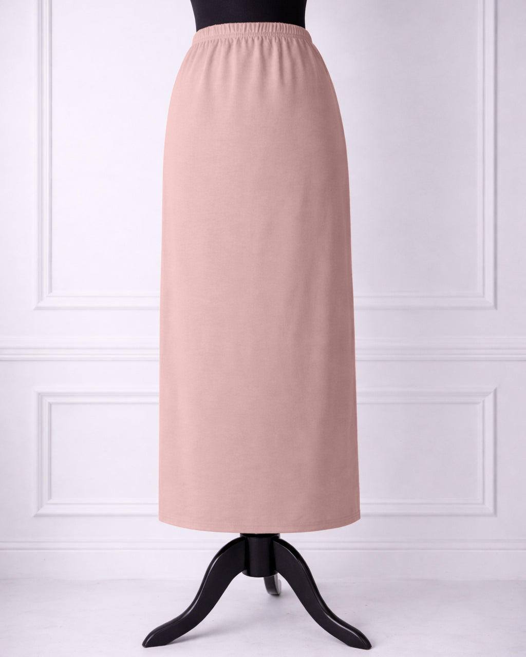 rose skirt on a mannequin against a white paneled wall.