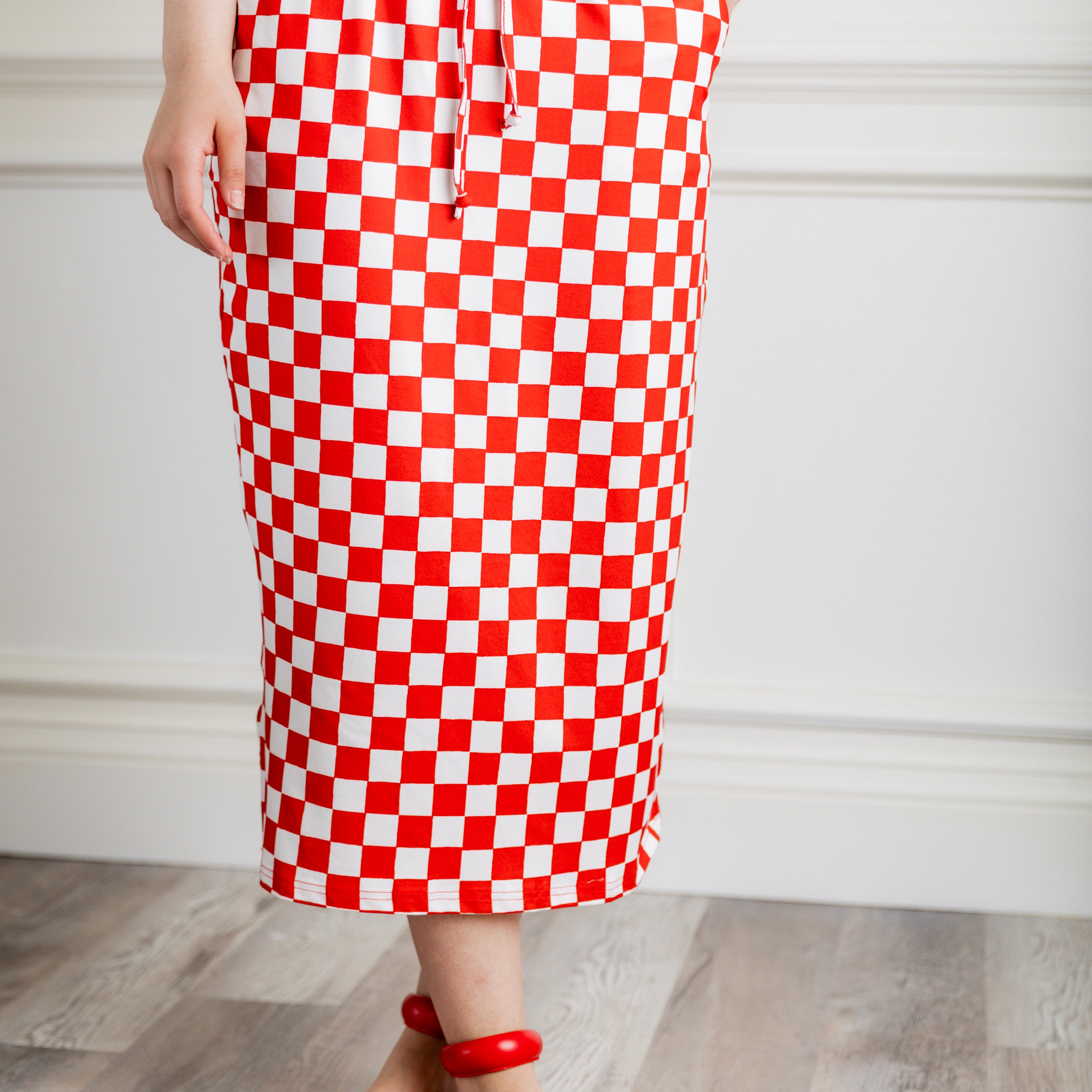Model wearing Nuggles® 31-inch Drawstring T-Skirt in prints. Modest midi skirt with side pockets, soft stretch waistband, and adjustable drawstring. Lightweight knit fabric, perfect for everyday comfort and style.