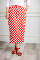 Model wearing Nuggles® 31-inch Drawstring T-Skirt in prints. Modest midi skirt with side pockets, soft stretch waistband, and adjustable drawstring. Lightweight knit fabric, perfect for everyday comfort and style.