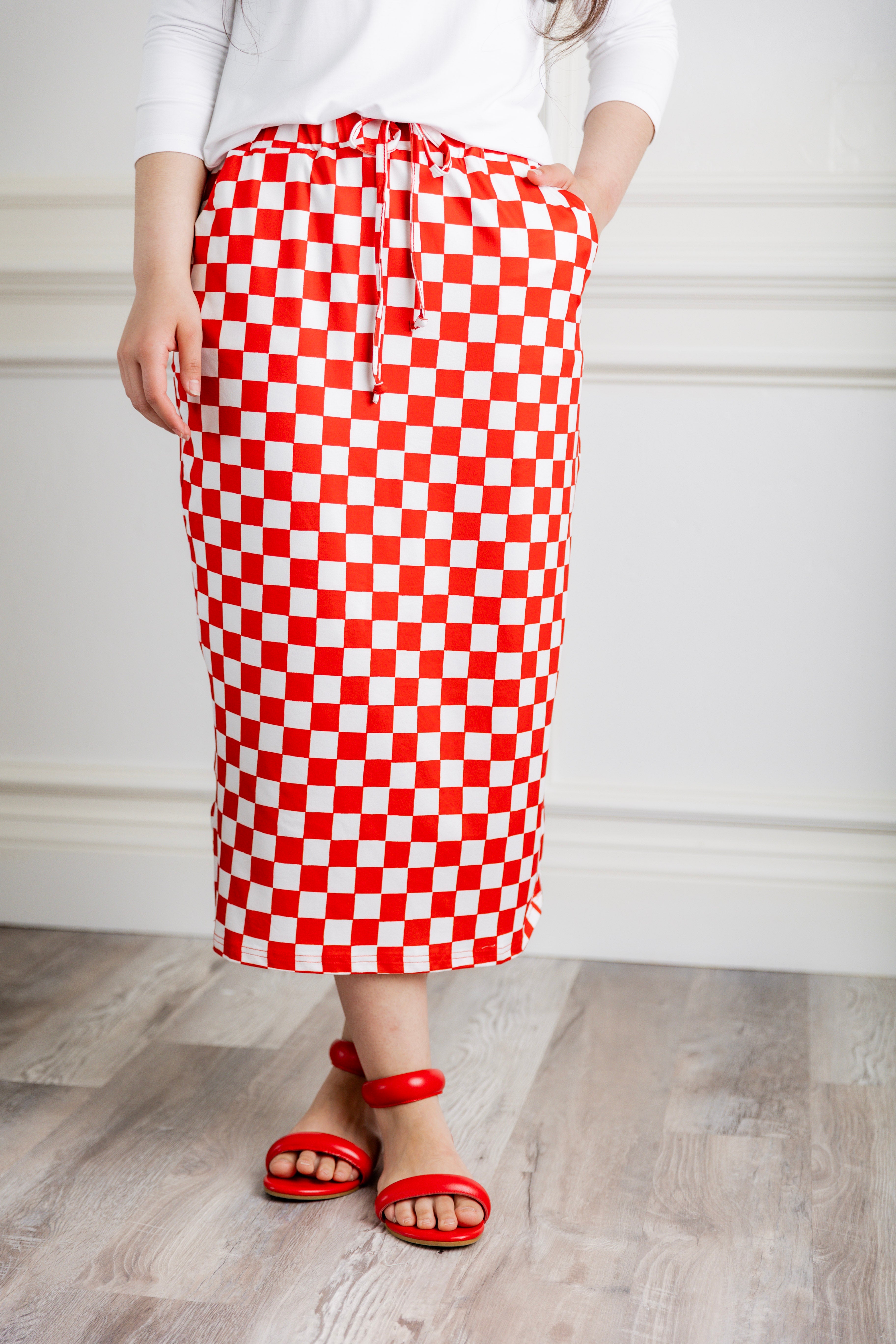 Model wearing Nuggles® 31-inch Drawstring T-Skirt in prints. Modest midi skirt with side pockets, soft stretch waistband, and adjustable drawstring. Lightweight knit fabric, perfect for everyday comfort and style.