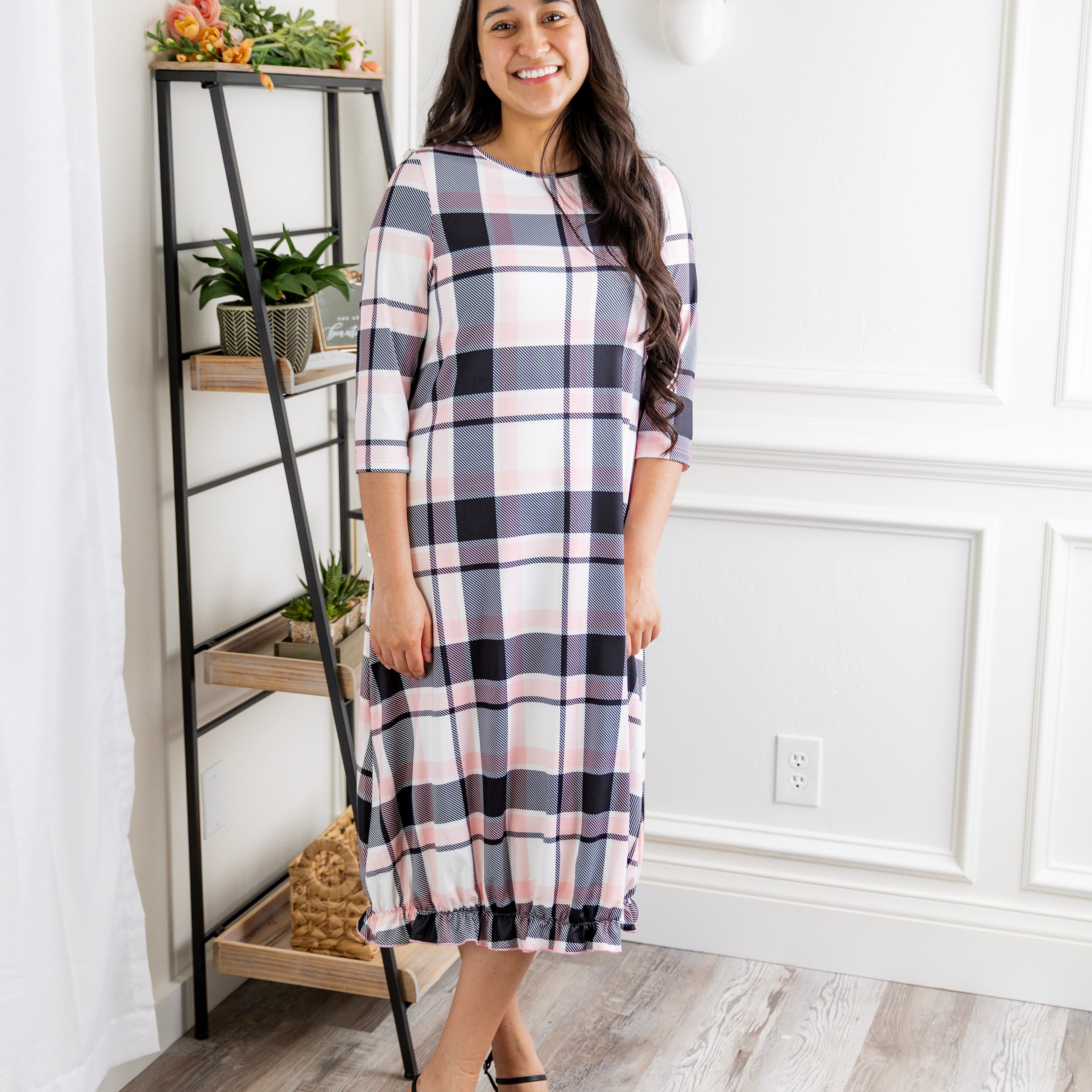 Model wearing our Nuggles® modest Bristol midi dress with 3/4 sleeves and elastic ruffle hem in various prints.
