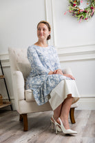 Modest light blue floral print tunic for women – Nuggles® Rose Top with high-low ruffle hem and 3/4 sleeves.