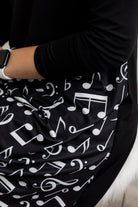 Model modeling Nuggles® Charay Dress with ¾ sleeves and high-low hem. Modest and stylish A-line dress with flattering fit.