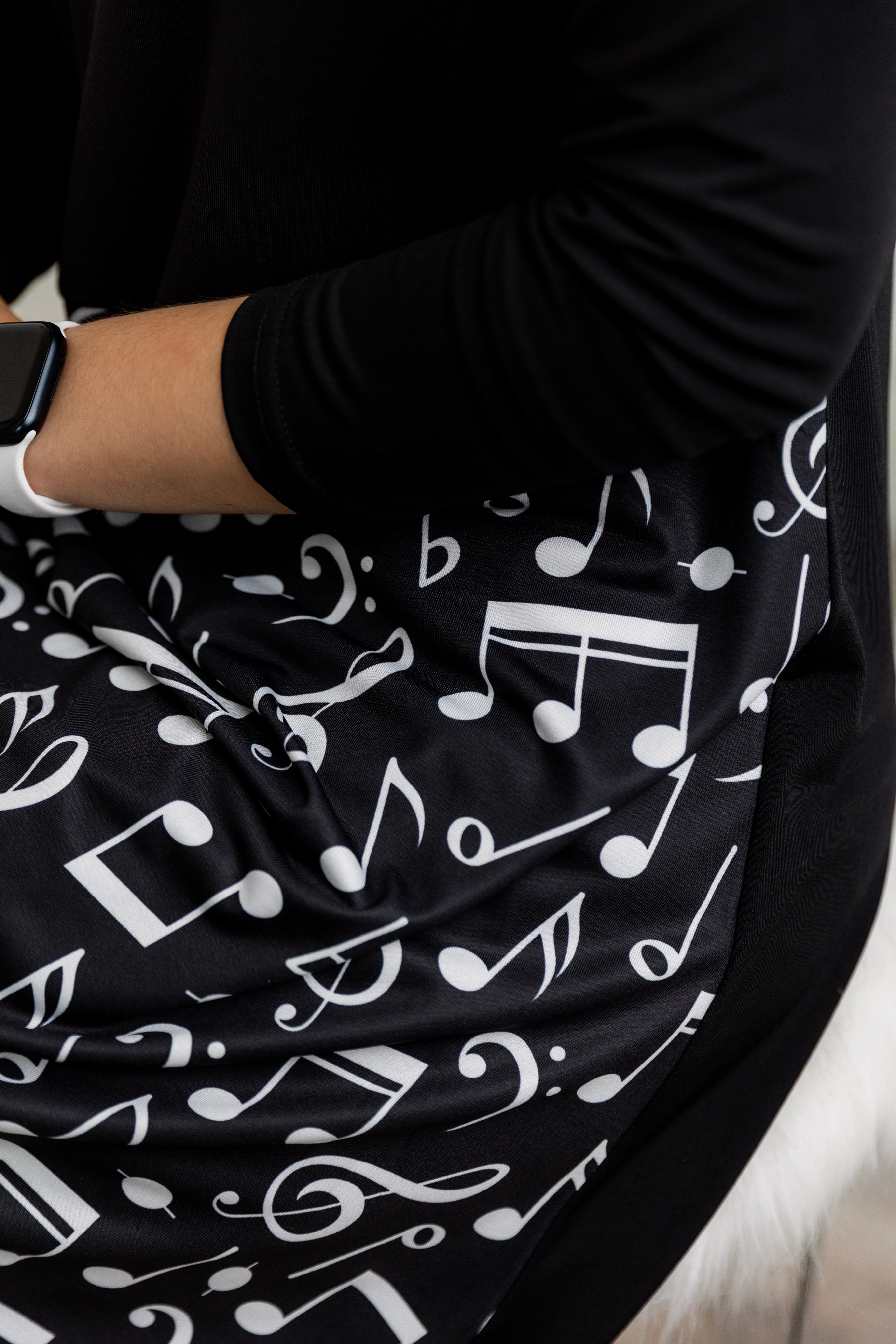 Model modeling Nuggles® Charay Dress with ¾ sleeves and high-low hem. Modest and stylish A-line dress with flattering fit.