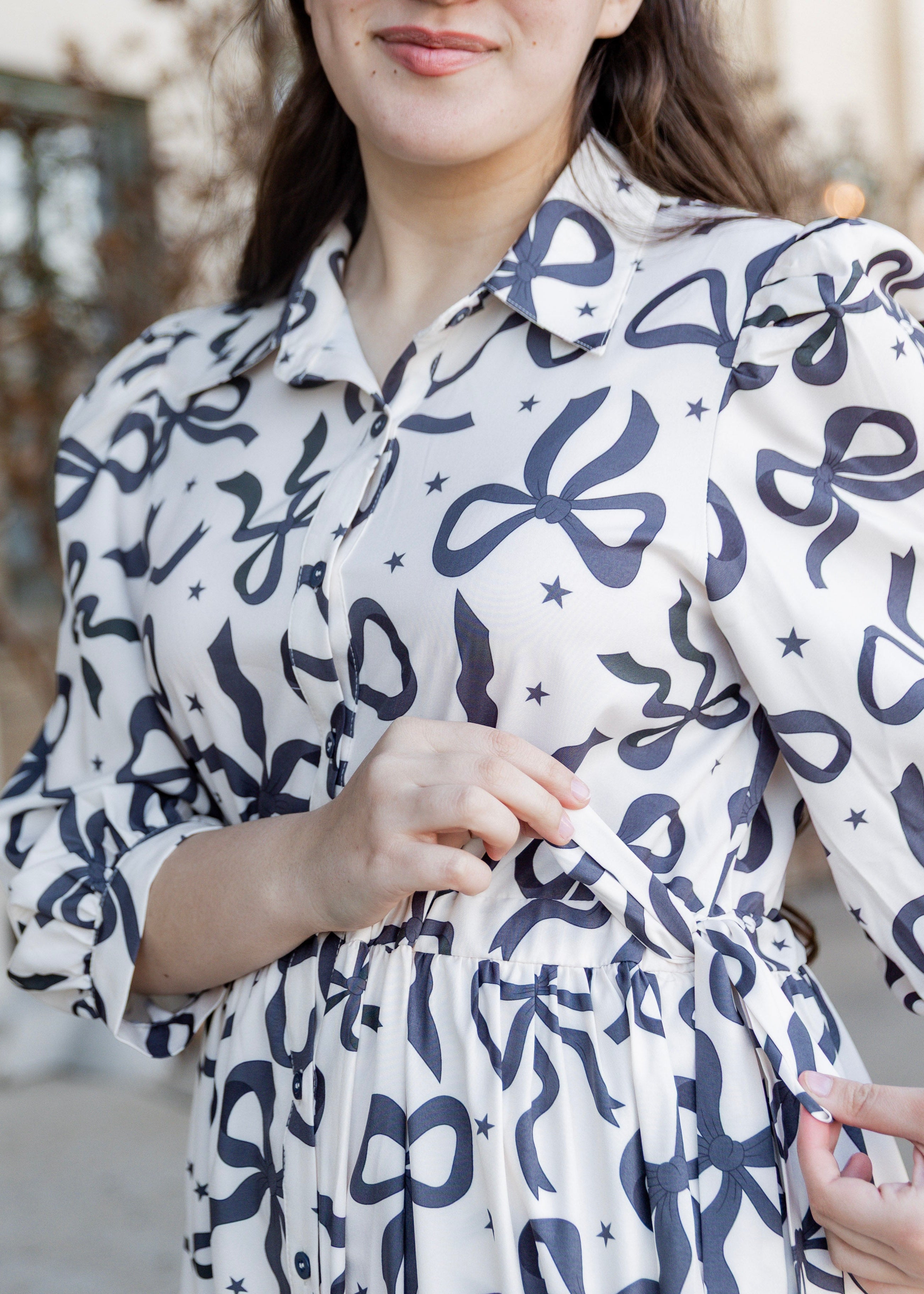 Model wearing the Nuggles® Leila Dress in Bow & Tell