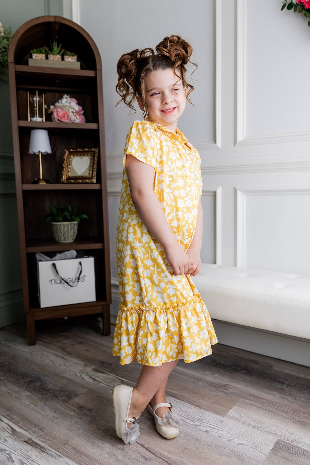 Model wearing Nuggles® Girls' Ellie Dress Dress in Sunshine Sprigs