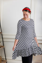 Modest women's black and white checkerboard ruffle tunic – Nuggles® Rose Top with 3/4 sleeves and swing hem.