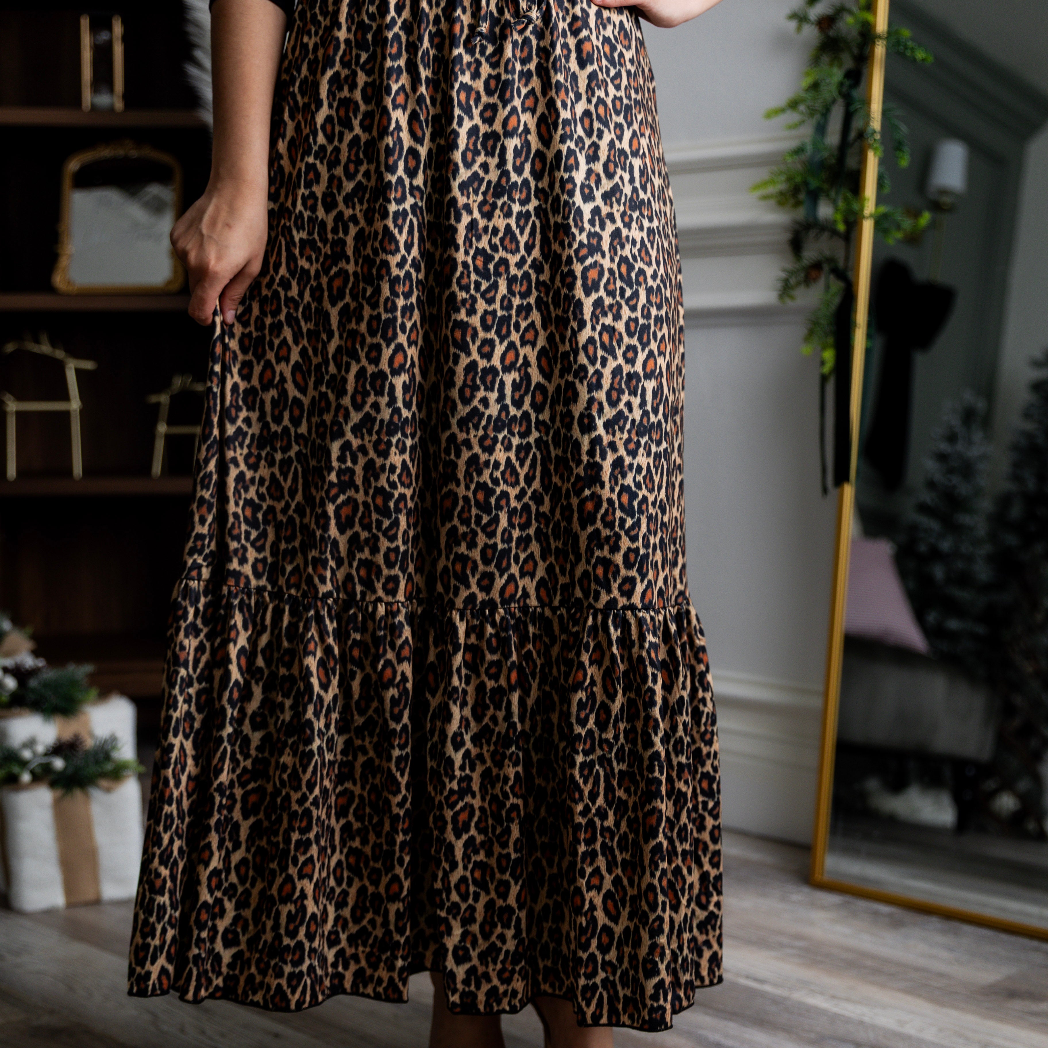 Model wearing the Nuggles® Sage Skirt in leopard print, designed with a flowy tiered hem and comfortable elastic waistband.
