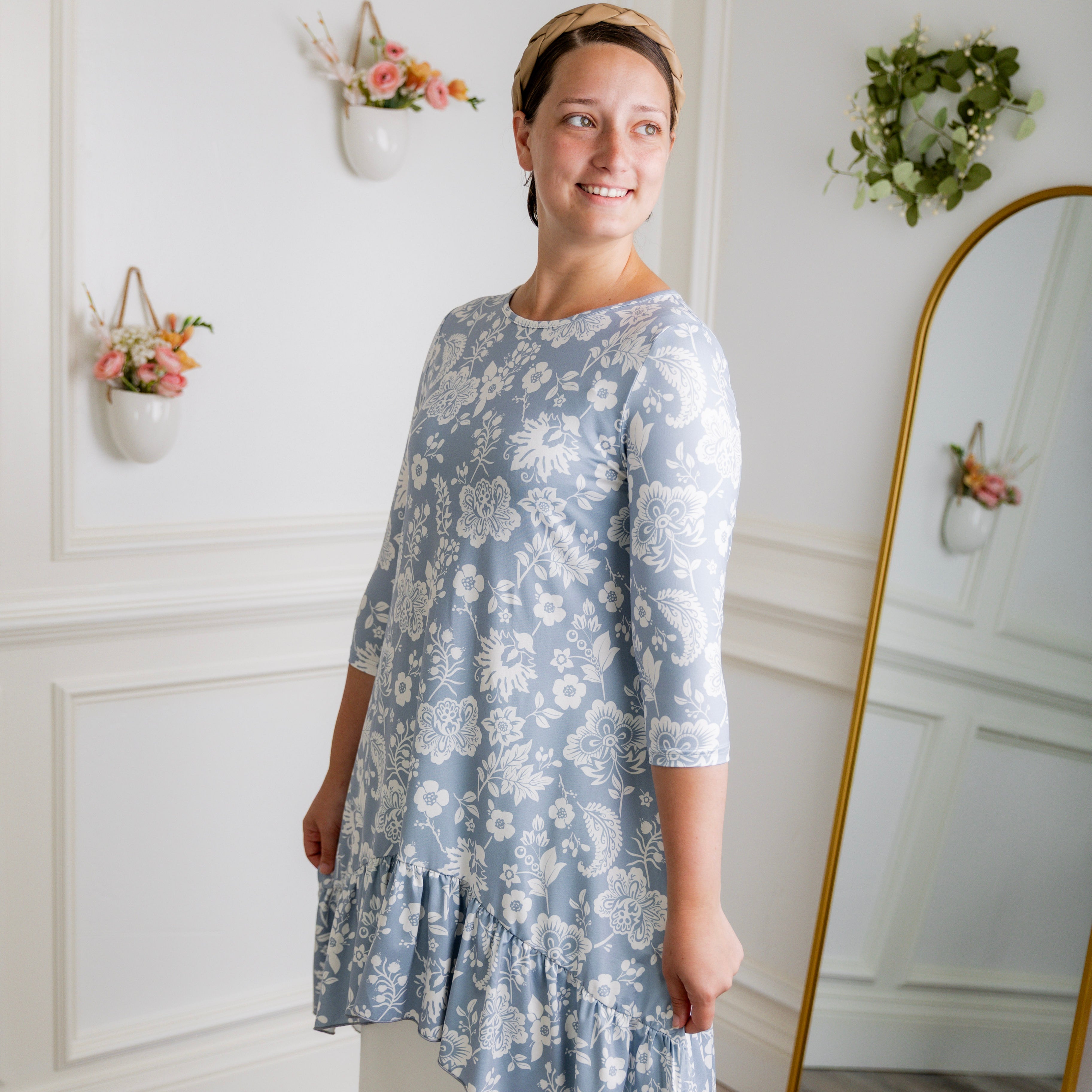 Modest light blue floral print tunic for women – Nuggles® Rose Top with high-low ruffle hem and 3/4 sleeves.