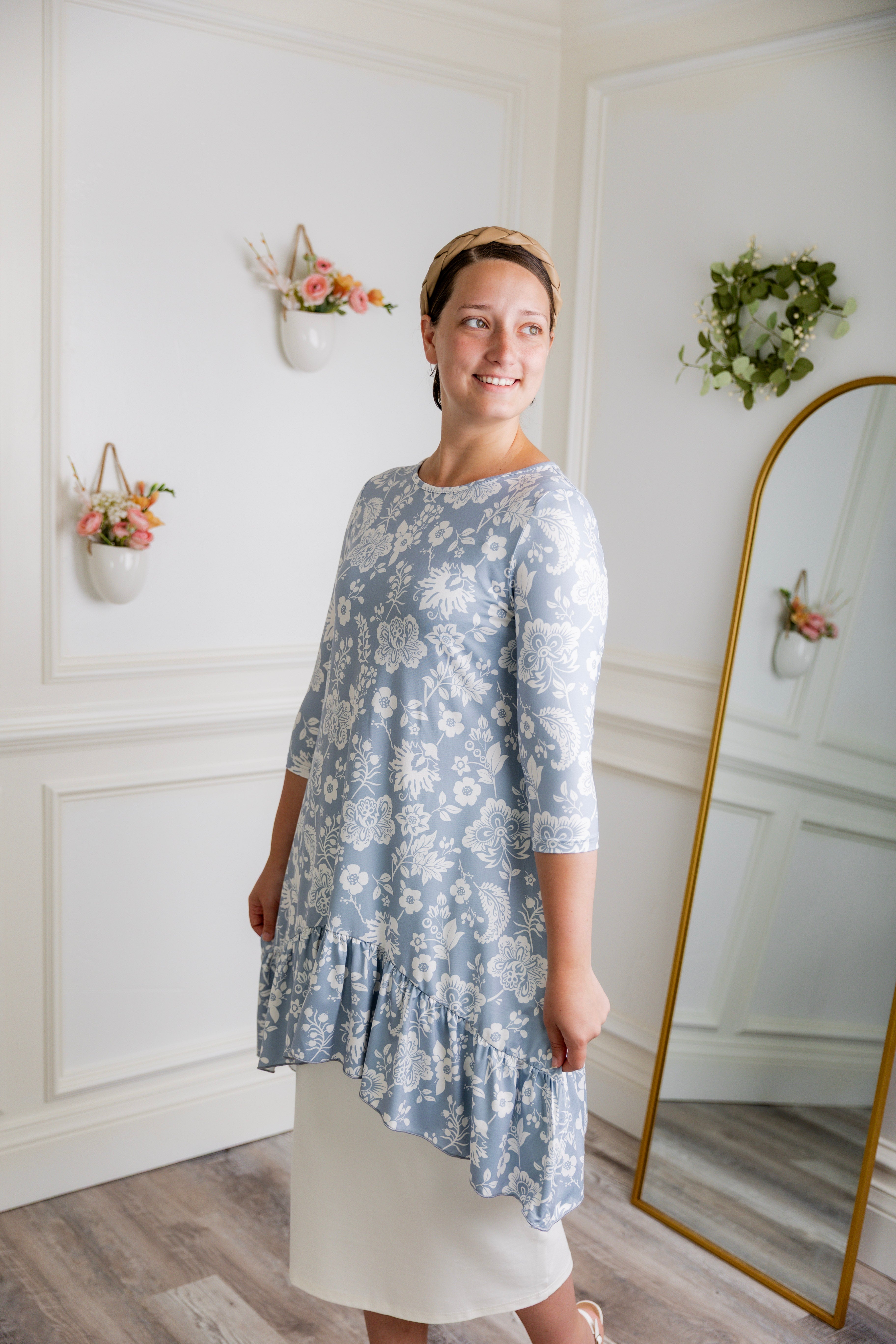 Modest light blue floral print tunic for women – Nuggles® Rose Top with high-low ruffle hem and 3/4 sleeves.
