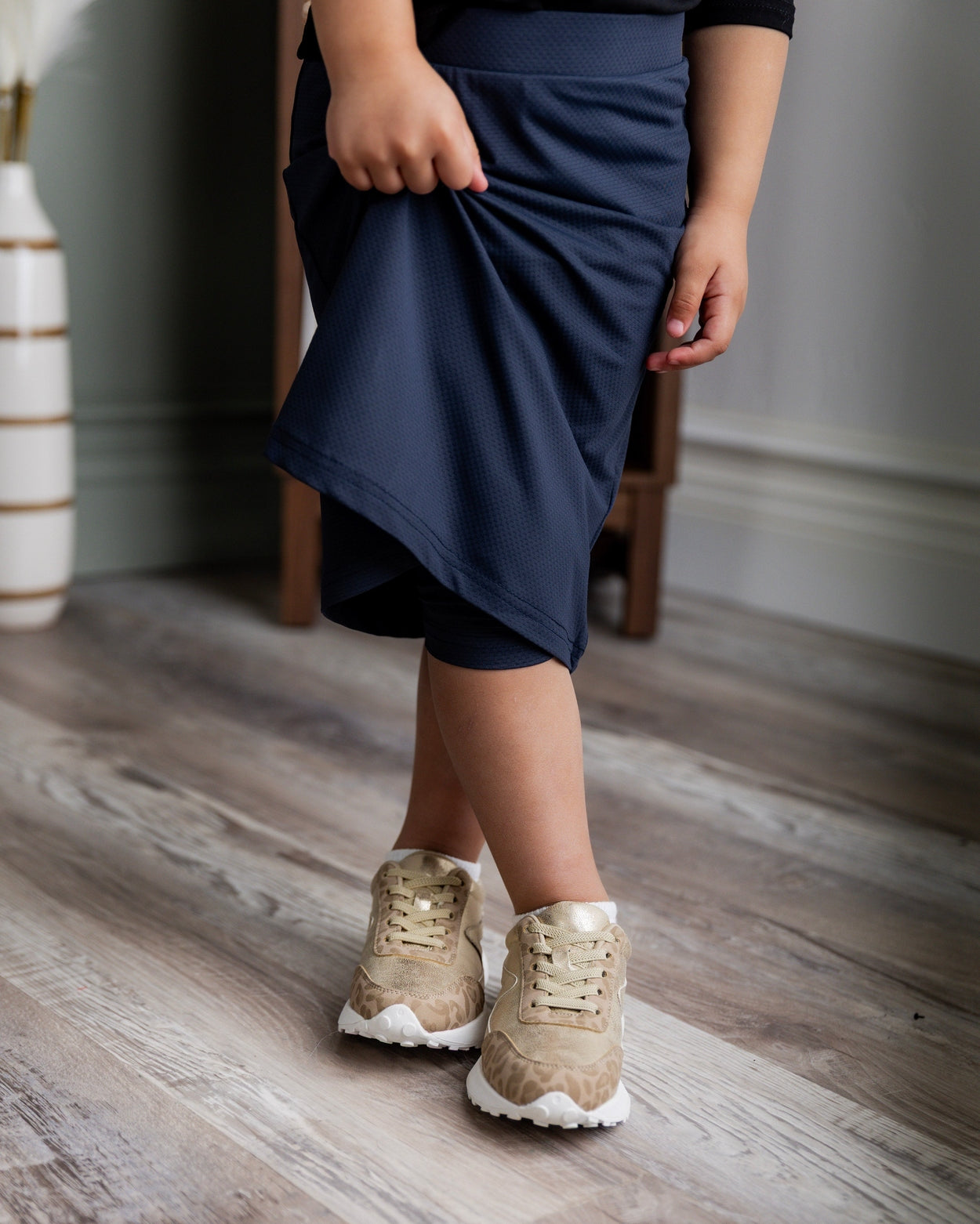 Model wearing Nuggles® Girls' All-Sport Skirt in Navy