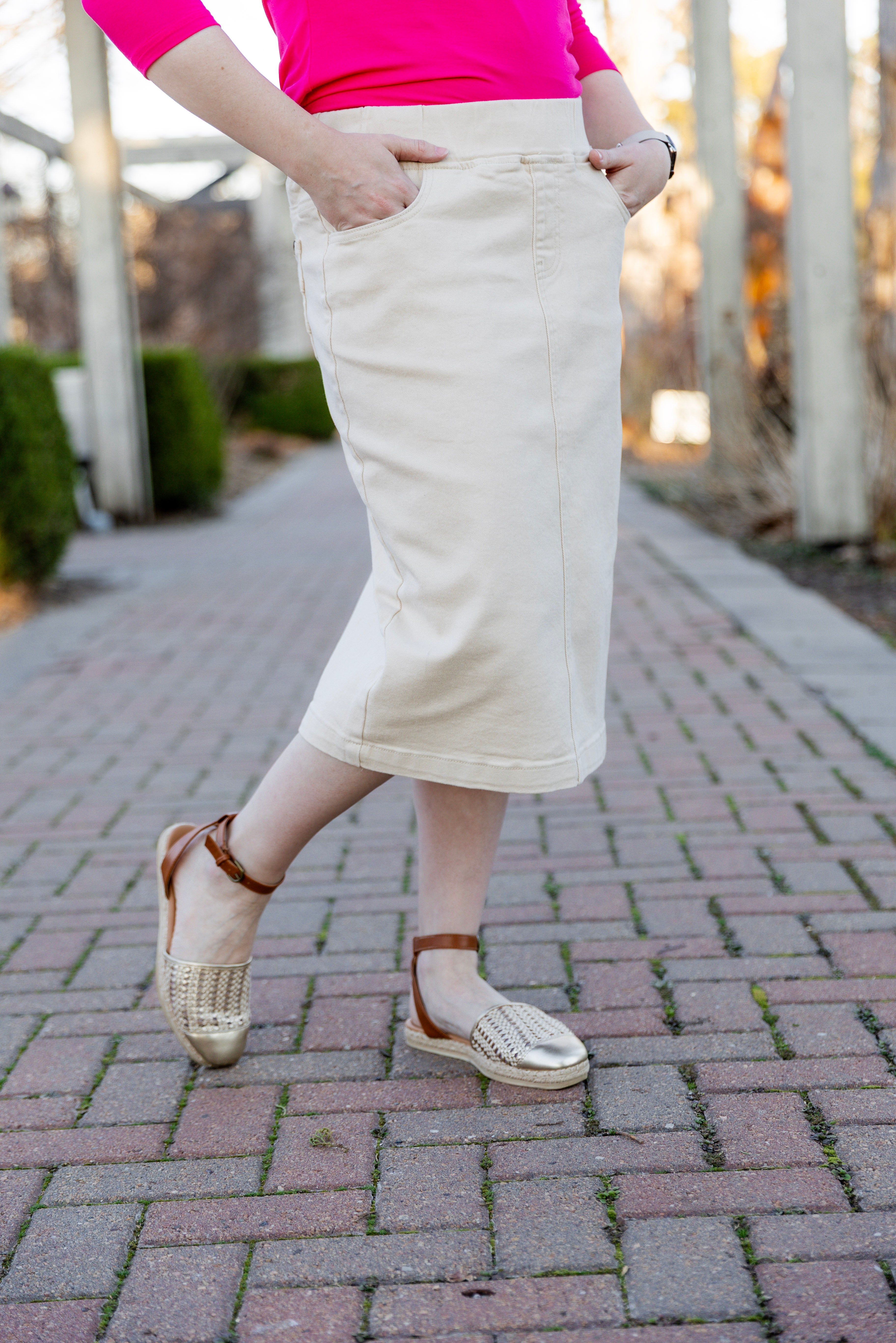 Nuggles® denim midi skirt with soft stretch fabric, wide elastic waistband, modest length, and functional pockets. Available in 27", 31", and 34" lengths.