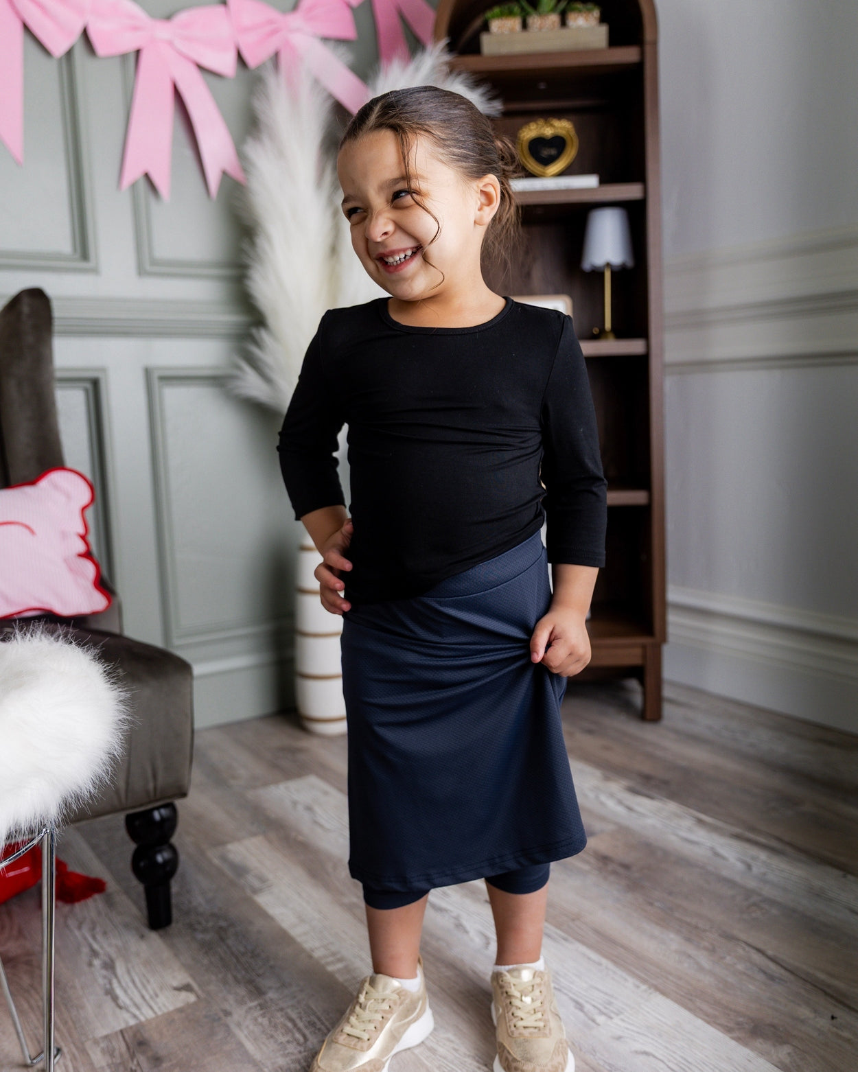 Model wearing Nuggles® Girls' All-Sport Skirt in Navy