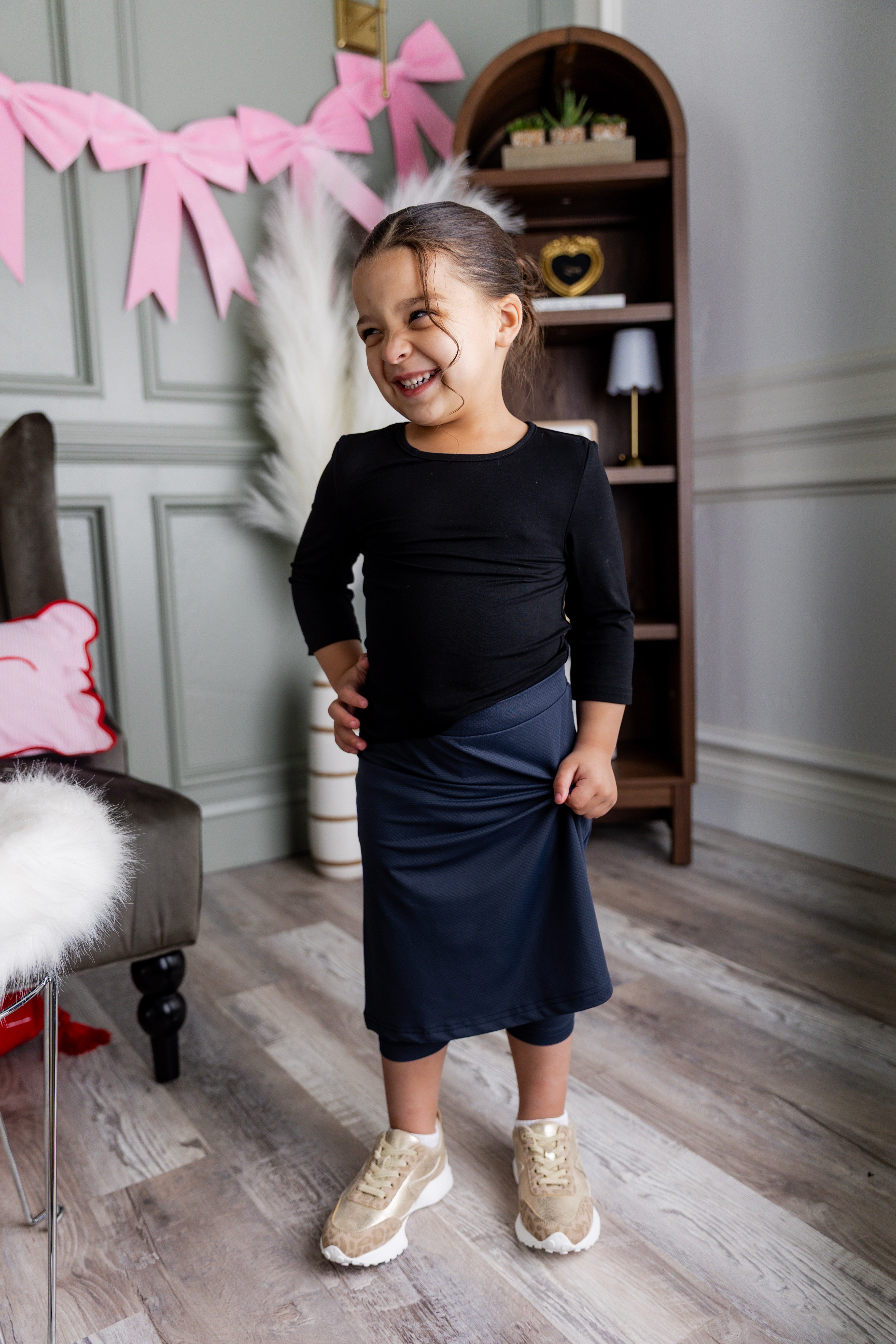 Model wearing Nuggles® Girls' All-Sport Skirt in Navy