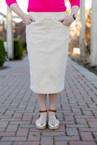 Nuggles® denim midi skirt with soft stretch fabric, wide elastic waistband, modest length, and functional pockets. Available in 27", 31", and 34" lengths.